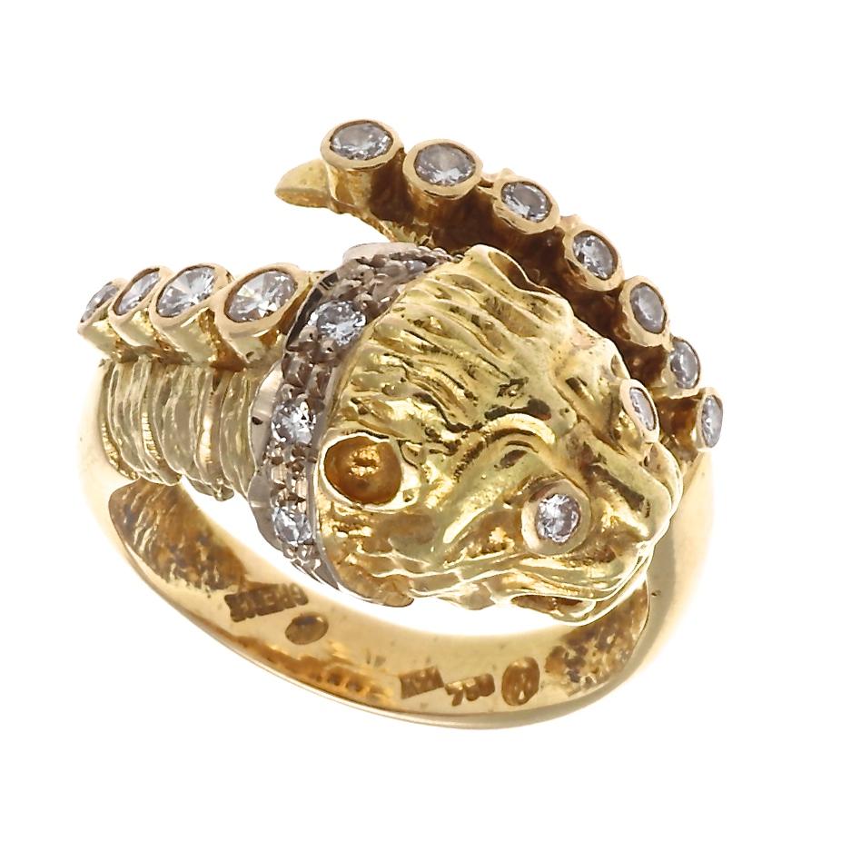 A 1960's treasure by an internationally renowned goldsmith, the perfect talisman to conjure strength and courage in changing times. This is Ilias Lalaounis's tiger head ring in 18k gold with 16 round brilliant cut diamonds that weigh approximately