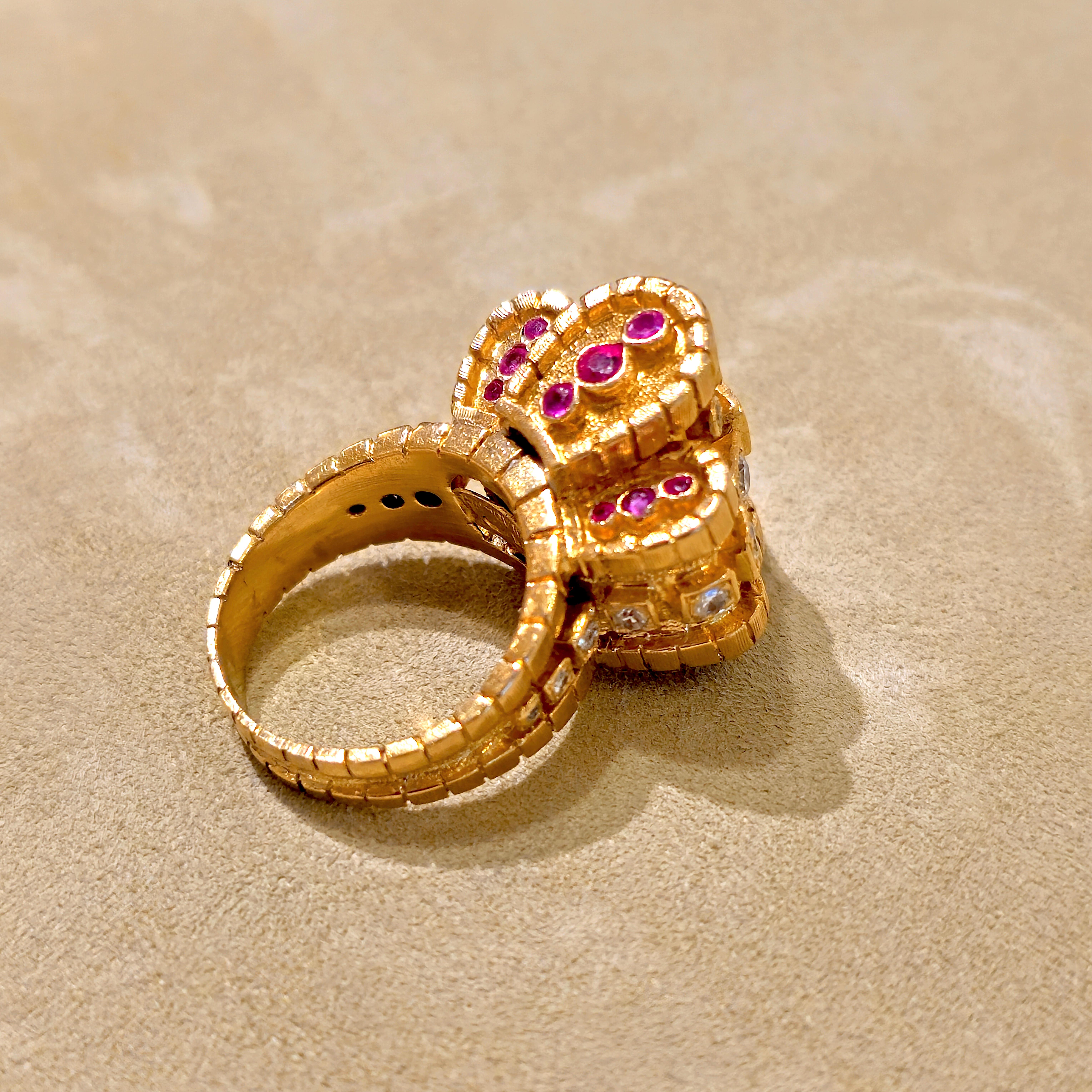 An early diamond, ruby, and 18-karat yellow gold cocktail ring by Ilias LALAoUNIS, Greece. This Ilias LALAoUNIS cocktail ring showcases a regal design with a  combination of sparkling full and single-cut diamonds of an estimated 1-carat total weight