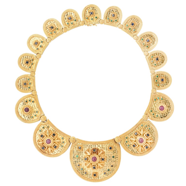 Ilias Lalaounis Etruscan Necklace with Rubies, Sapphires and Emeralds in 18 Karat Yellow Gold. This unique piece by Greek Master Jeweler Ilias Lalaounis exemplifies the designer's creativity while remaining true to their Greek roots and cultural
