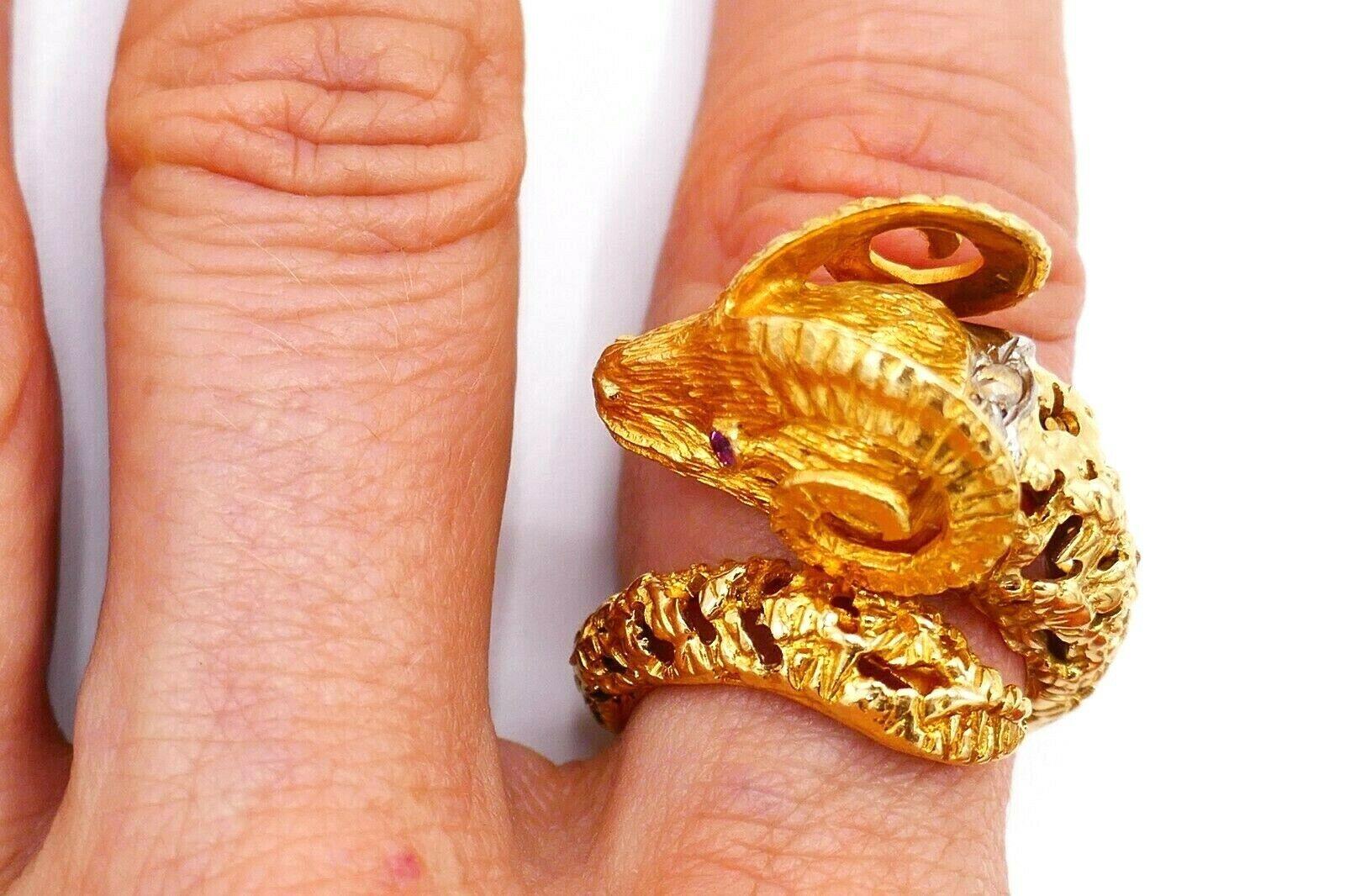 Gorgeous bypass Ram/Aries ring by Ilias Lalaounis made of 18k yellow gold featuring ruby and a rose cut diamond. Has an amazing filigree work providing the ring an airy look. 
Measurements: the ring size is 6.5; 3/4