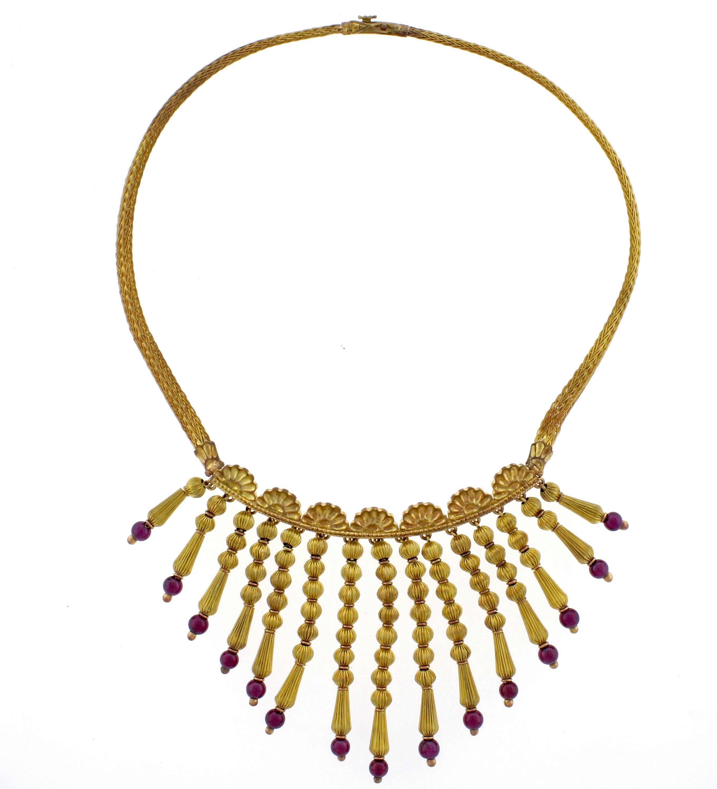 From acclaimed Greek  jeweler  Ilias Lalaounis, this dramatic tassel necklace. The 18 karat gold necklace is comprised of 15 tassels graduating  from 1 to 2¼ inches and terminating with a garnet bead.  70.5 grams, 16 inches   