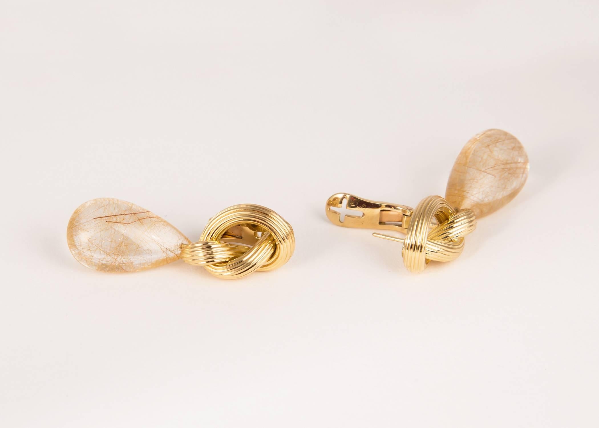 Elegant rutilated quartz drops shimmer below simple knot motif tops. Ilias Lalaounis designs are classic.        1 7/8's inches in length. 