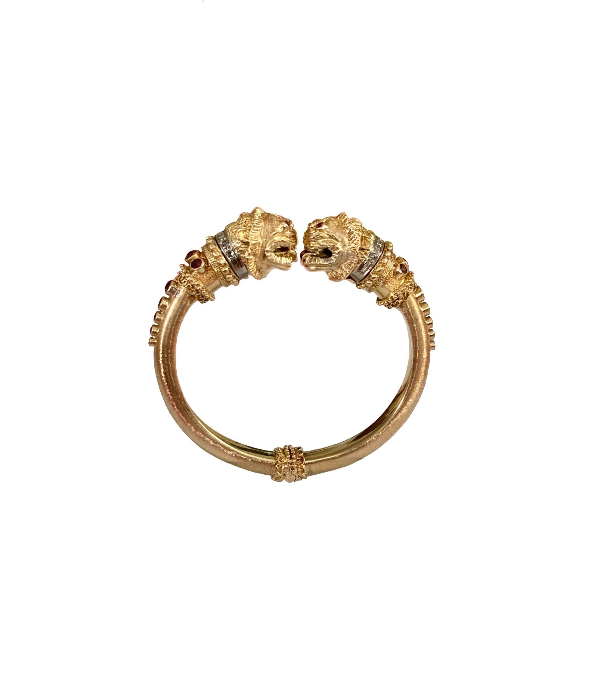 Exquisite piece from Ilias Lalaounis, this 18 kt. yellow & white gold hinged bangle is designed with double lion's head with diamonds and rubies. 

Metal: 18k yellow gold
Diamonds: 14 brilliant-cut
Stones: Bezel-set 18 round rubies
Dimensions: head
