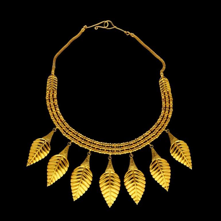 Necklace length 41cm, central leaf drop is 5.5cm
Circa 1980's
148 grams

A stylish and bold gold necklace by Lalaounis c.1980's, designed as a triple row of textured beads over a hand woven chain with seven graduated leaf shaped motifs suspended