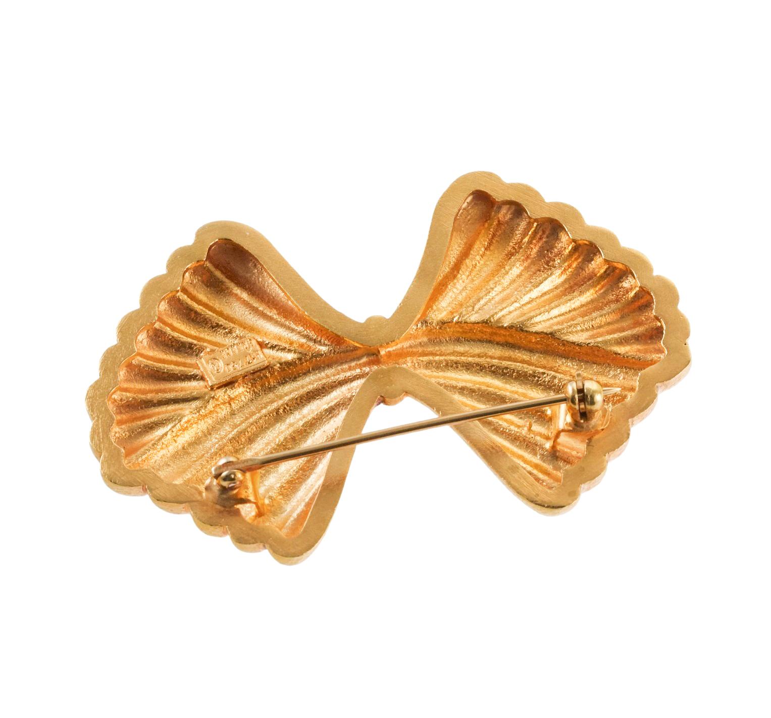18k yellow gold bow brooch, crafted by Ilias Lalaounis of Greece, featuring polished and hand hammered finish. Brooch measures 2