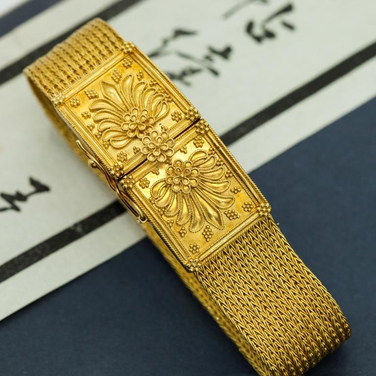 Ilias Lalaounis Greece woven band bracelet in 18-karat yellow gold featuring ornate insert tab clasp. Hallmarks: Ilias Lalaouins, Greece, 750, H17.

Weight: 50.90 gm
Measures: Length clasped 6.25