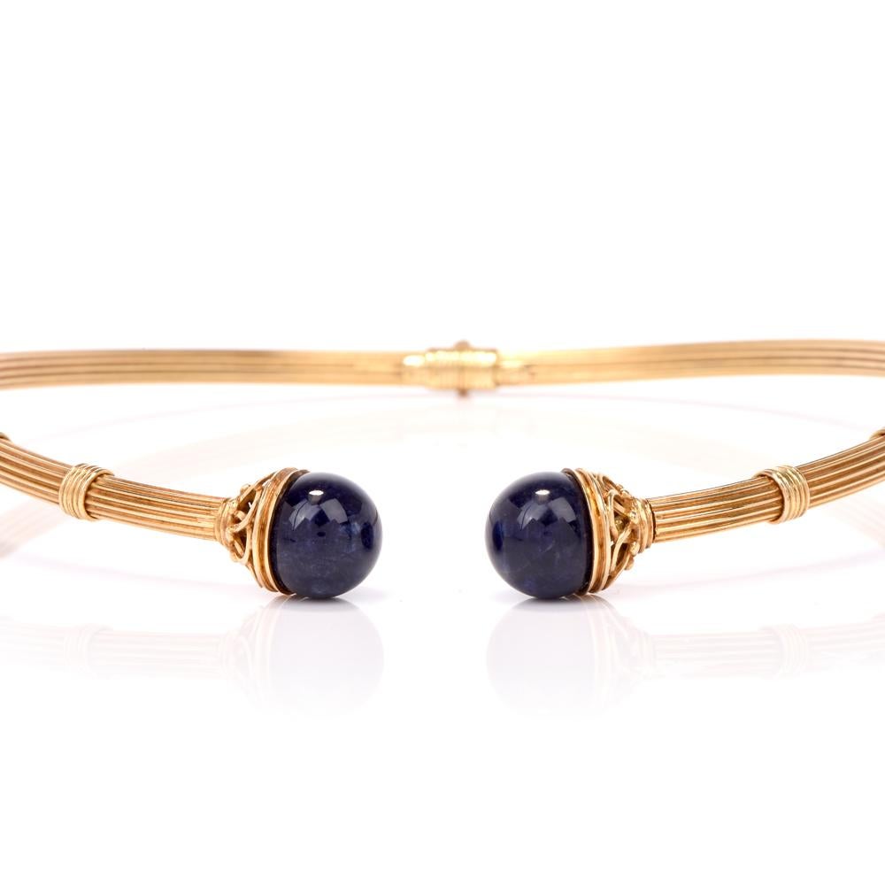 This exquisite vintage lapis lazuli torque style collar necklace is hand crafted in 18-karat yellow gold. Featuring two lapis lazuli drops measuring approx. 14mm, bezel-set in filigree open work baskets. Necklace weighs 59.7 grams and measures 15
