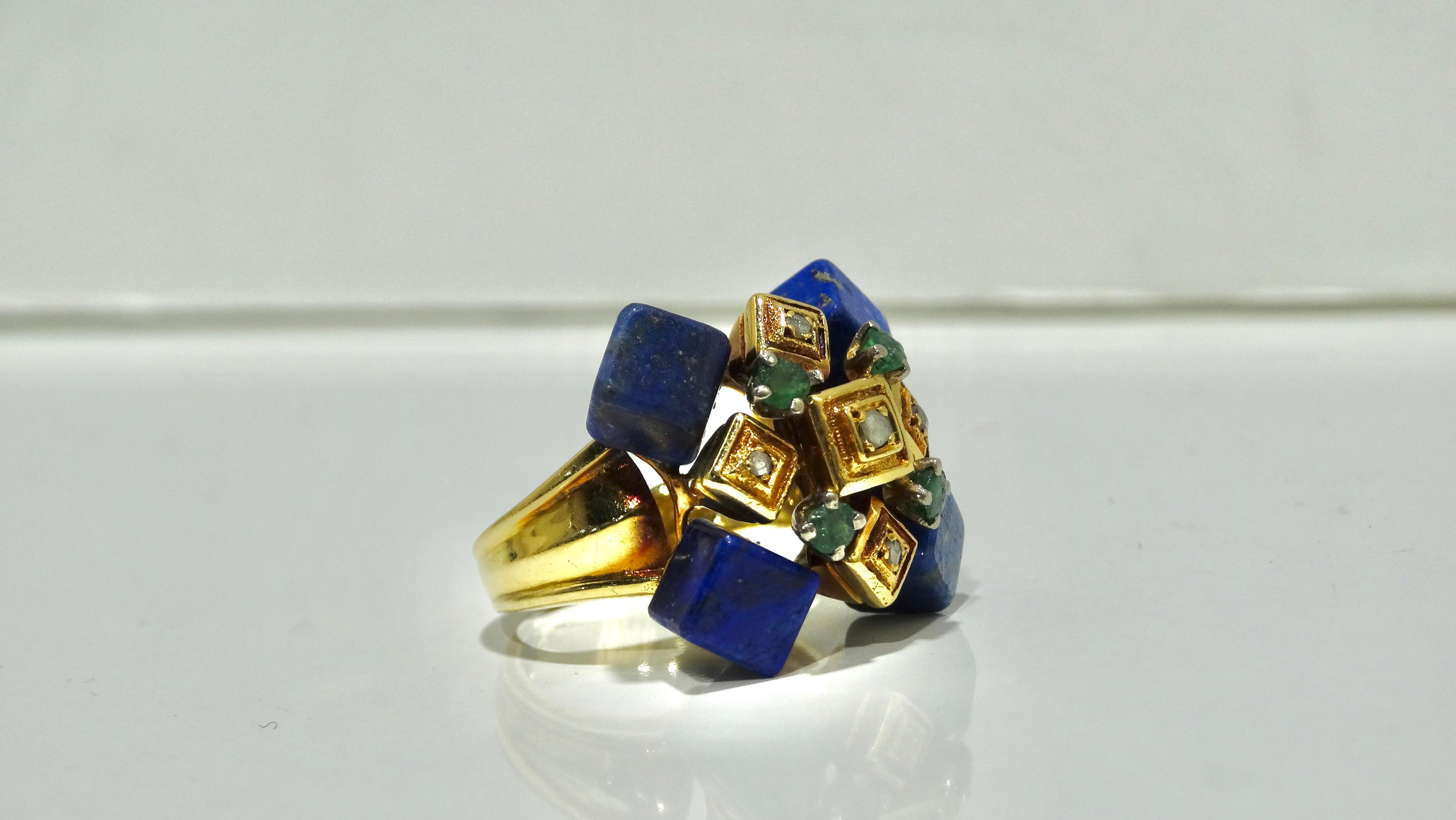 Beautiful Ilias Lalaounis, three stone ring containing 4 lapis lazuli cubes, 4 round cut Emeralds, and 5 rose cut diamonds. The band was made with 18k gold (marked 750). Ring weights 11.72 grams Size 5 
