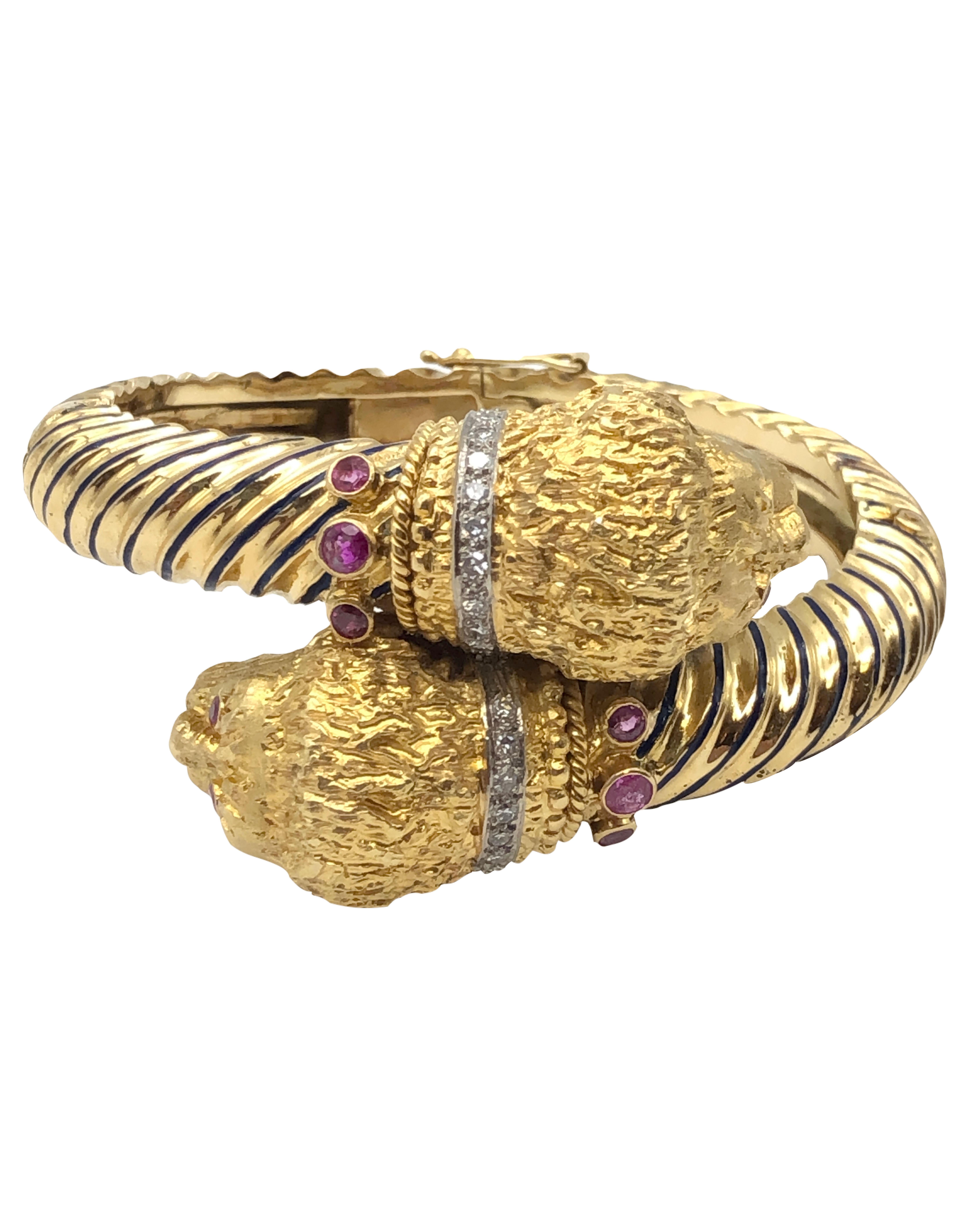 Circa 1970s Ilias LaLaounis Large and impressive 18k Yellow Gold Chimera Bracelet, the Chimera Heads each measure  3/8 X 3/4 inch, and are finely Detailed and Textured, each head having a Diamond set Collar, a Ruby collar and Ruby Eyes. the Heads