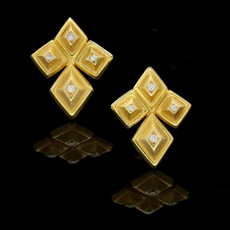 8 Round brilliant cut diamonds estimated to weigh a total of 0.2 carats
18 Carat yellow gold with maker's marks
3cm long and 2.4cm wide
11 grams

A stylish pair of 18 Carat yellow gold geometric earrings by Lalaounis c. 1970s, designed as a cluster