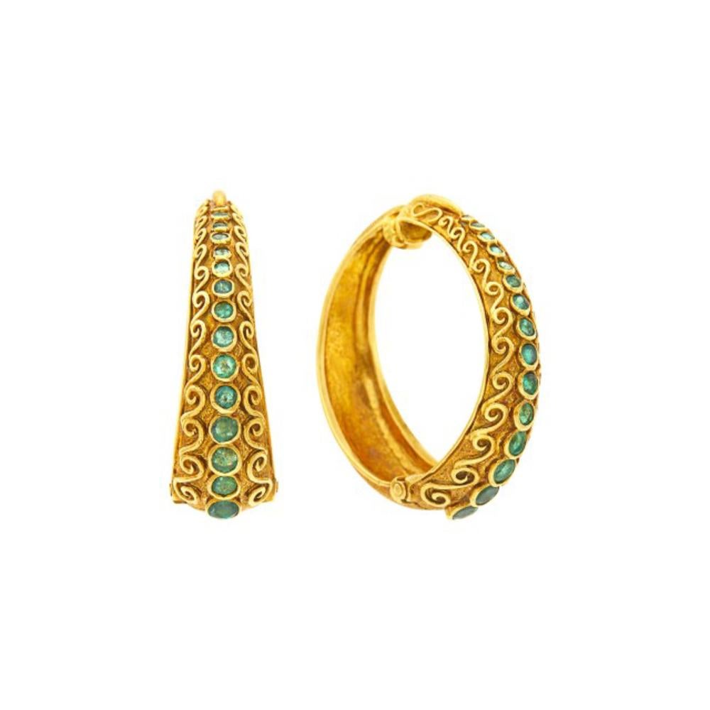A vintage pair of Ilias Lalaounis gold and emerald hoop earclips, showcasing 29 small round emeralds set in solid 18k gold. Signed Lalaounis, Greece, with maker's mark.

Hinged hoops. 1 5/8 x 1/2 to 3/16 inches. 