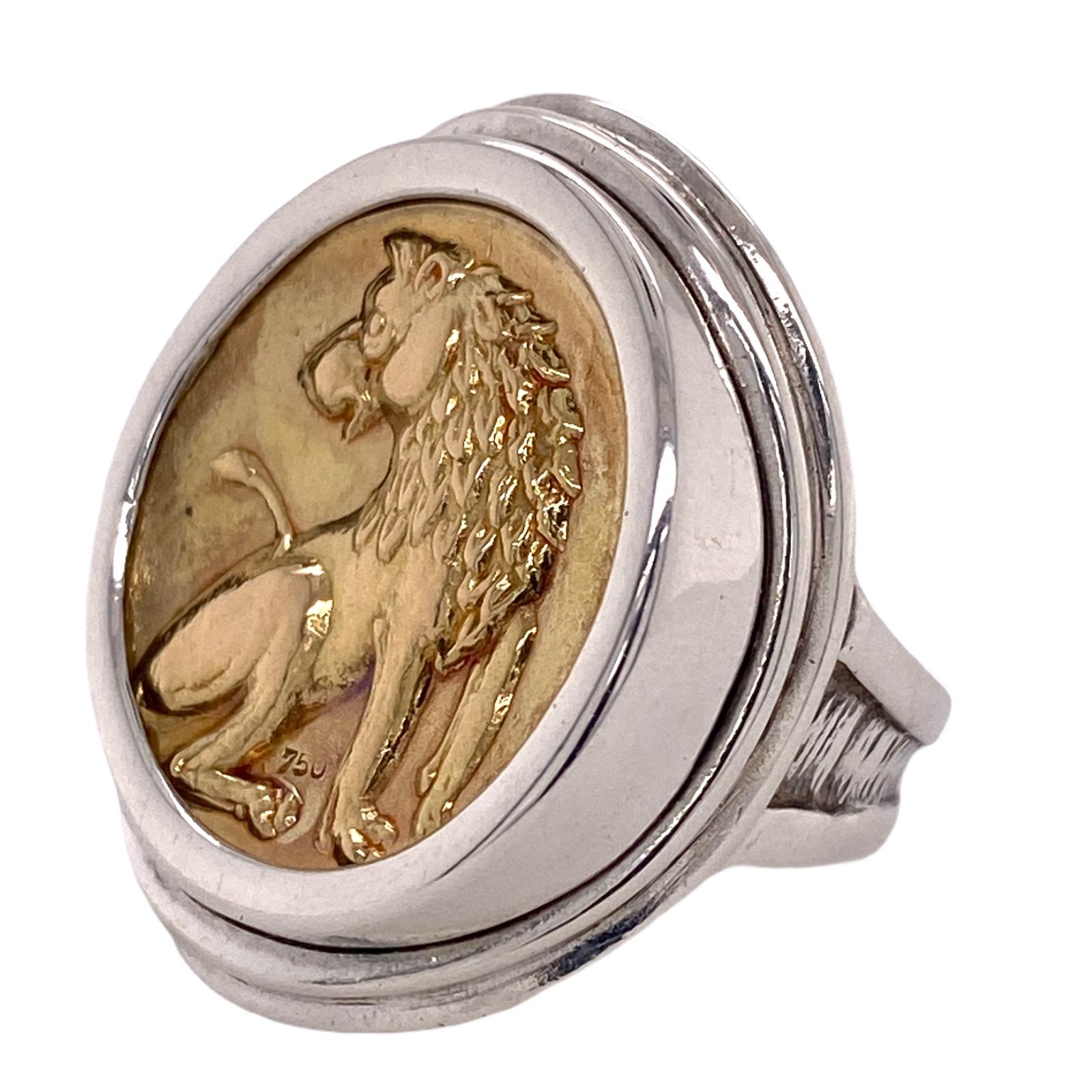 Ilias Lalaounis coin ring fashioned in sterling silver and gold plated sterling silver (two tone). The center coin shape medallion features an embossed wolf. The top measures 22 x 28mm, and the ring is currently size 5.5 (can be sized). Signed