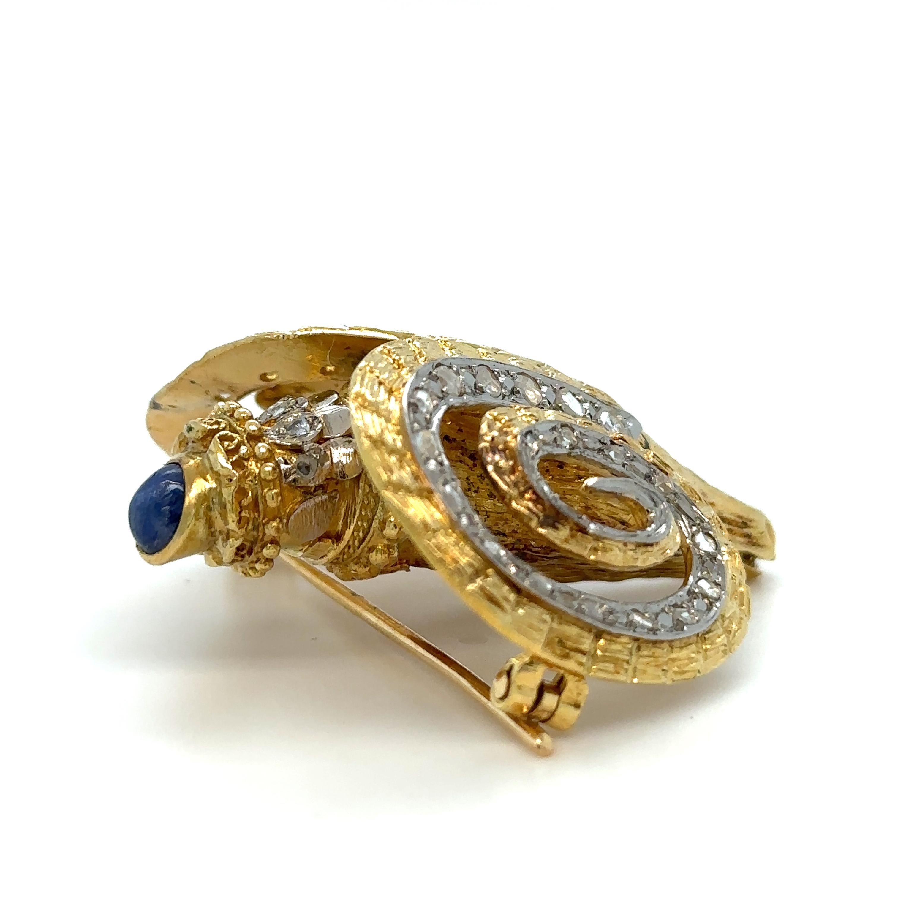 Unique features: 

Ilias Lalaounis Vintage Ram's Head Brooch, modelled as a ram's head in textured gold, the horns and collar embellished with diamond chips, the eyes collet-set with rubies and the neck surmounted by a cabochon sapphire, gross