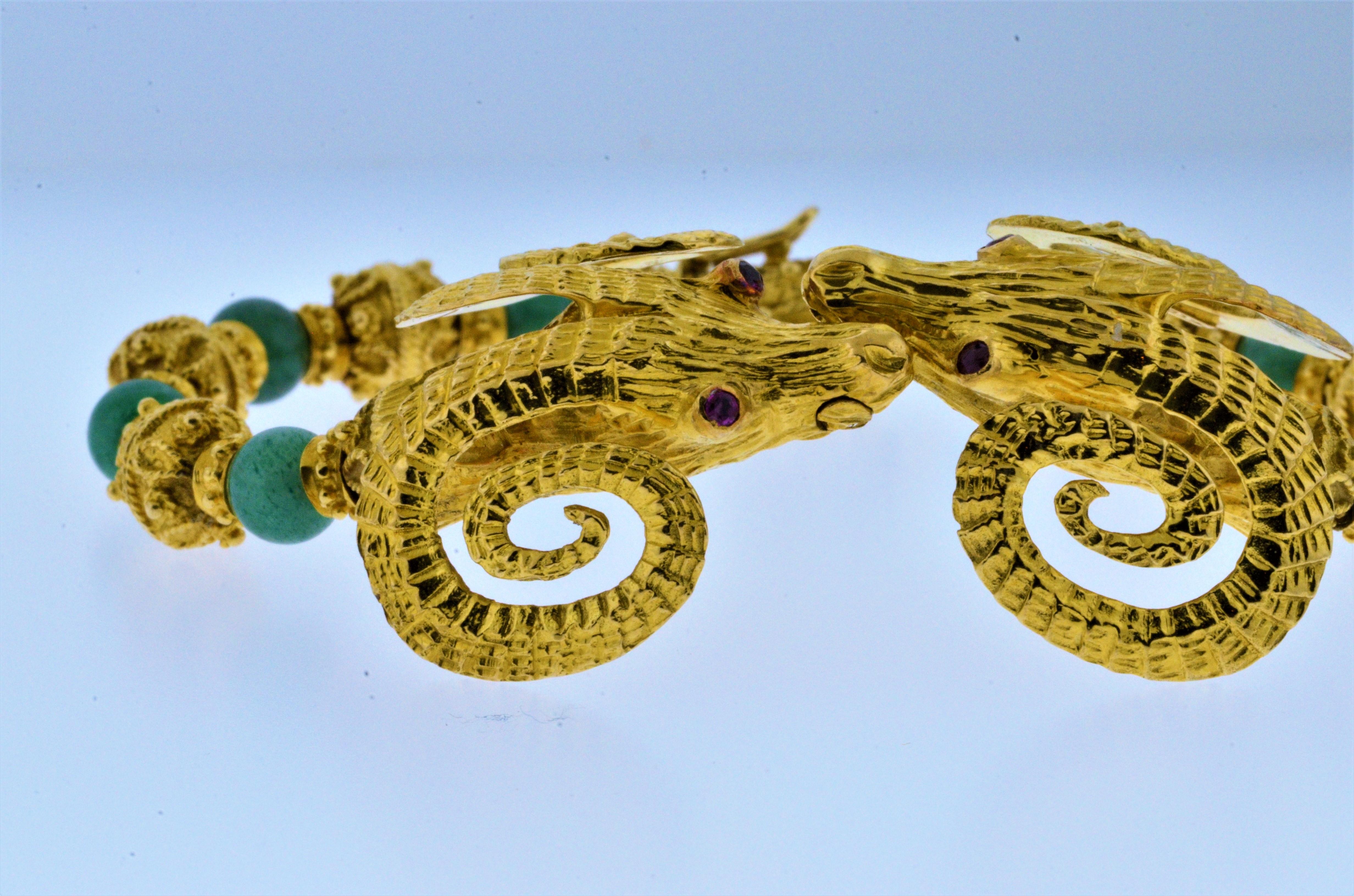 Beautifully crafted bracelet by designer Ilias Lalounis features two kissing ram heads embellished with ruby eyes and Amazonite Quartz beads. The Ram's Head in Greek mythology is a sign of prosperity.