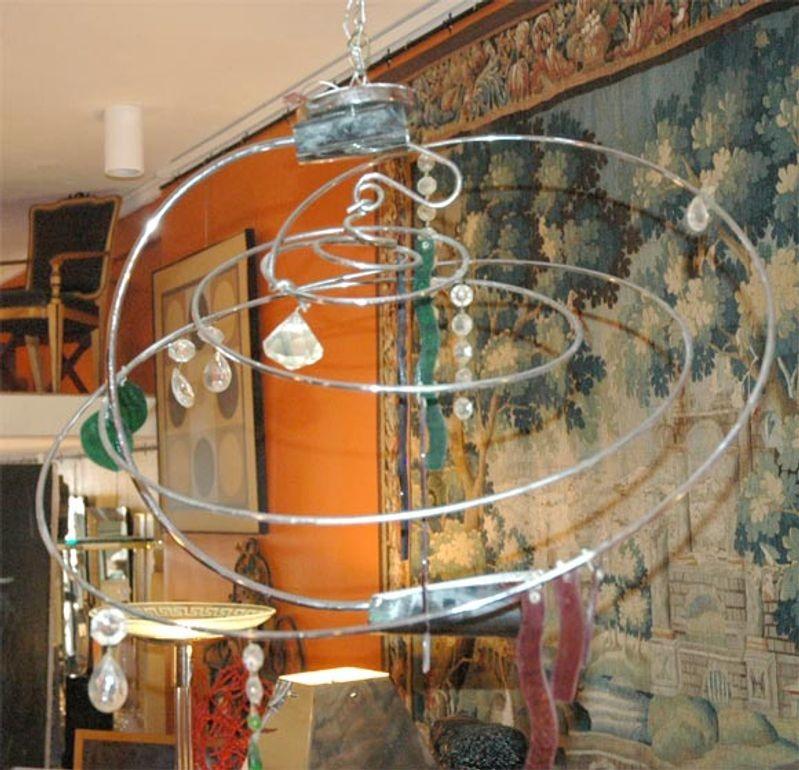 Impressive abstract chandelier by the renowned Italian designer Toni Cordero di Montezemolo for Artemide.
The chandelier's structure is made of chrome with suspended freeform cut Murano colored and clear glass.
Made in Italy, c. 1970's.
*Rewired to