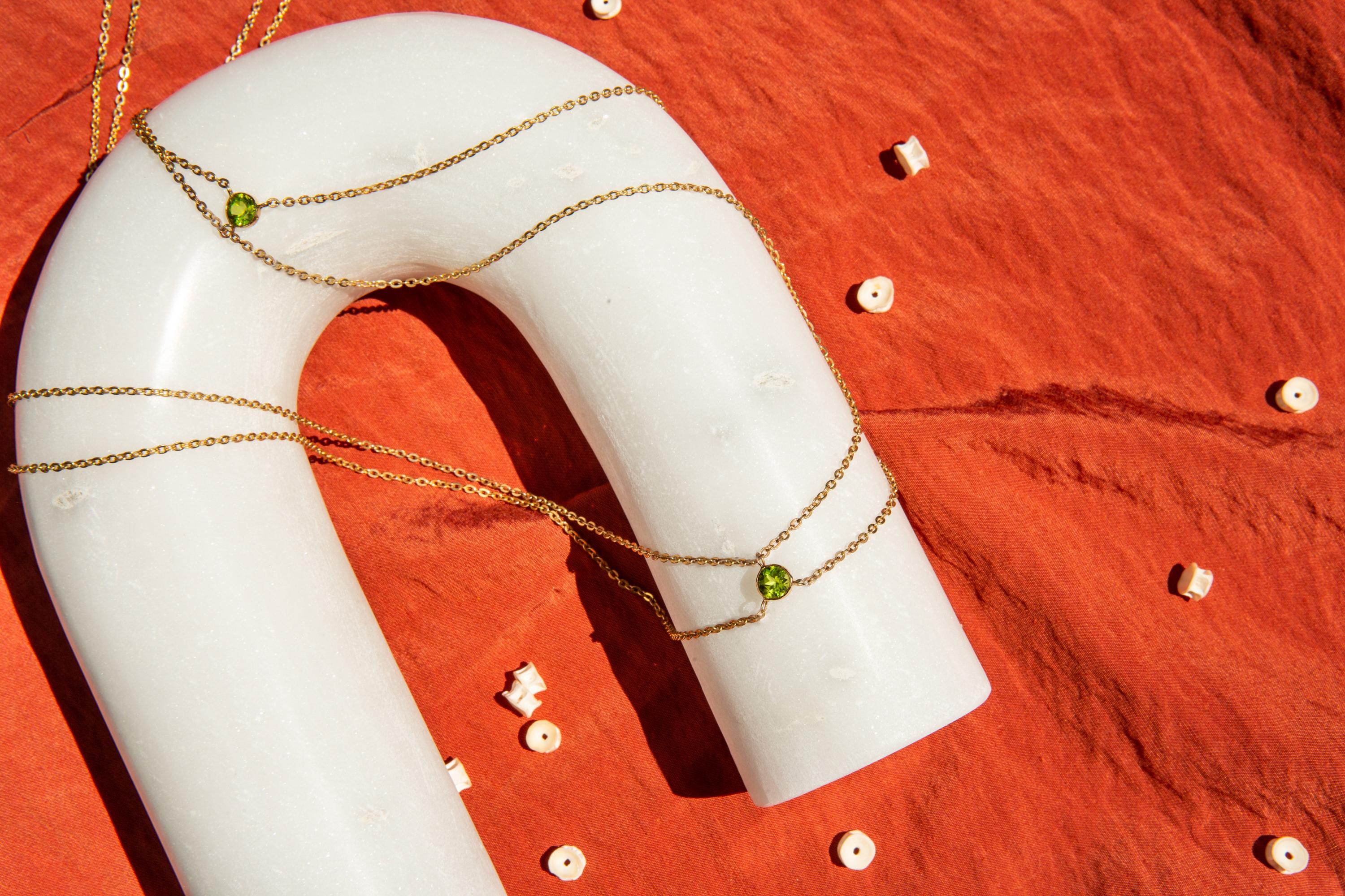 The Summon 14k gold waist chain by Ilium Wing is a poem to the feminine. As some peridot crystals have been found in meteorites, this piece features three dip-and-join meeting points across the hips, reminding us that a woman's body is the meeting