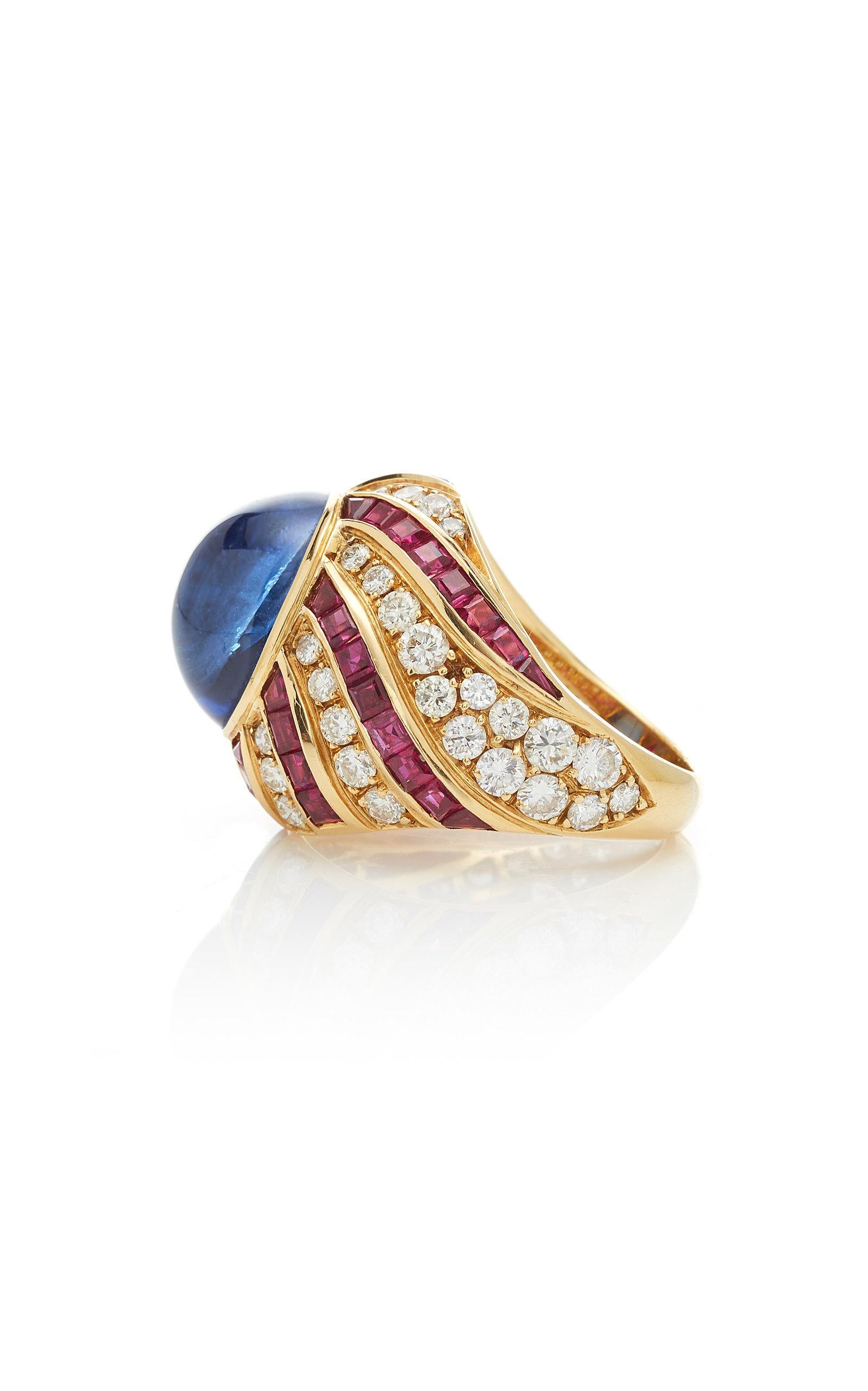 A beautiful ring of vortex design in 18kt yellow gold showcasing a cabochon ceylon sapphire (8 cts), square cut rubies and brilliant cut diamonds. Made in Italy by historical Northern Italian jeweler Illario, circa 1975.