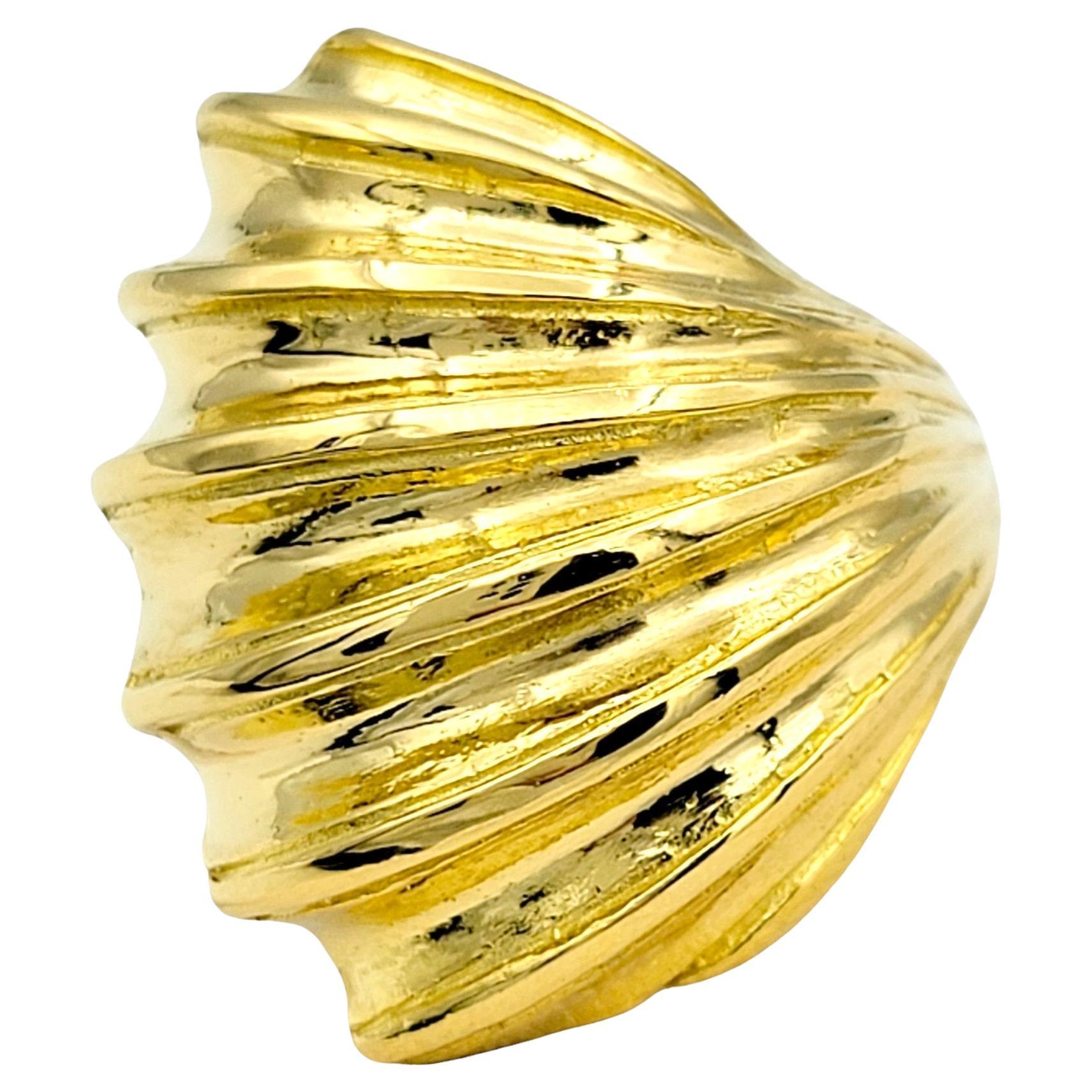 Ring Size: 5.25

This gorgeous Ilias Lalaounis shell design ridged wrap ring, crafted in 22 karat yellow gold, is a stunning piece of jewelry that captures the essence of nature's beauty. Inspired by the intricate patterns and textures of seashells,