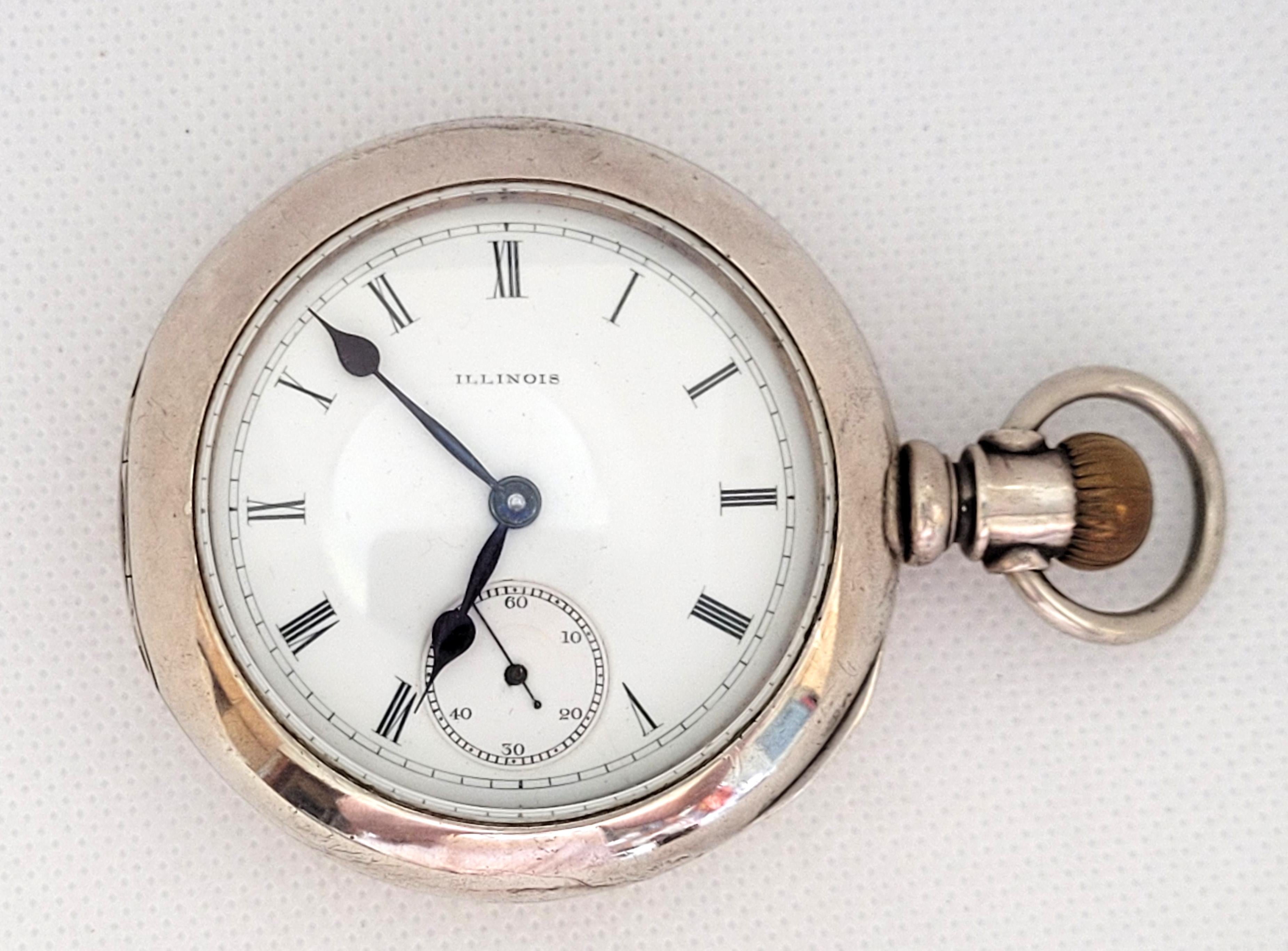 Heavy 1886 Ilinois watch with a 58mm silver color case (18s size) that has a thick clean glass crystal. There are slight dings on the case. The movement is 7 jewel, hunting, working, and serial number 964103. Overall this pocket watch is in very