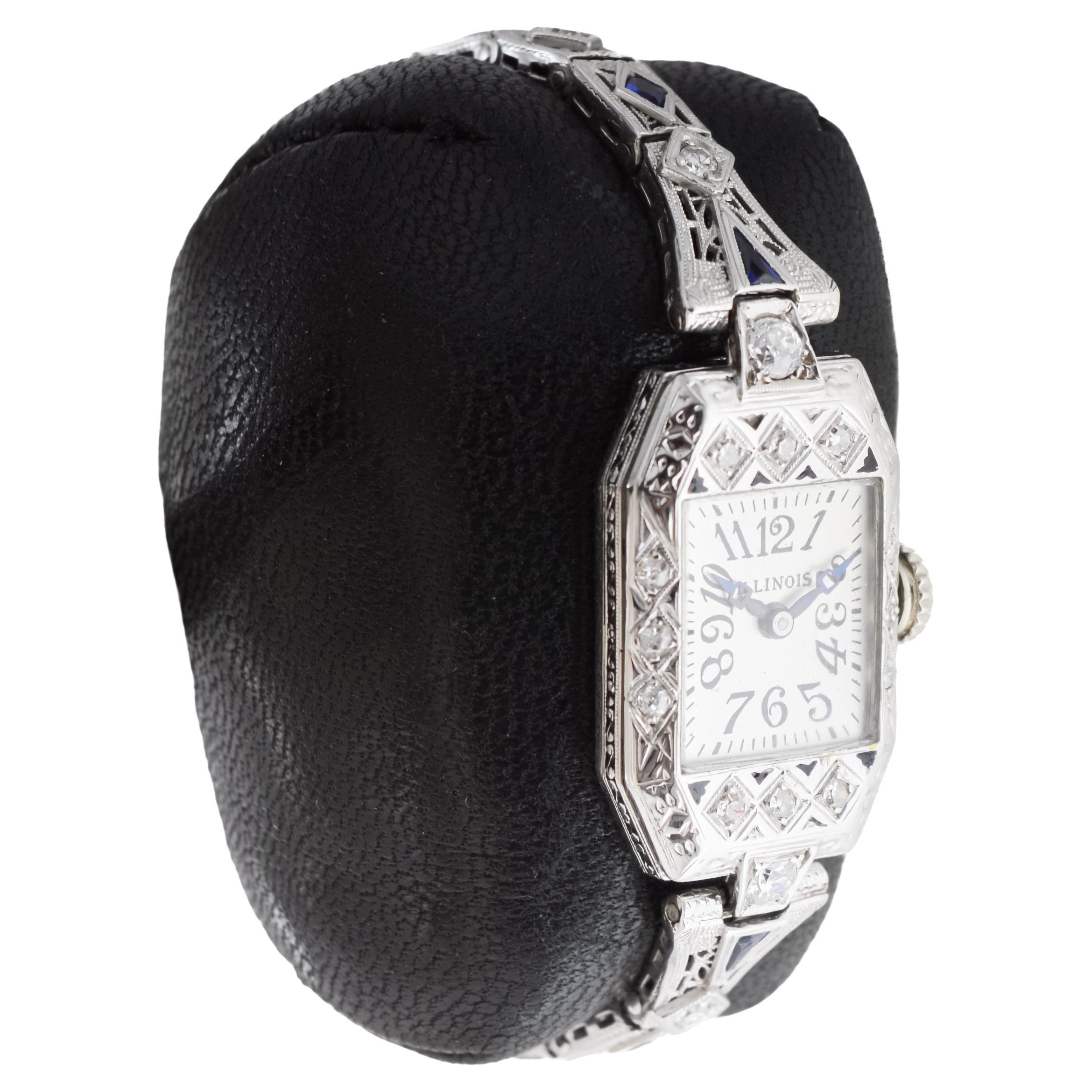 FACTORY / HOUSE: Illinois Watch Company
STYLE / REFERENCE: Art Deco / Dress Watch 
METAL / MATERIAL: 18Kt Solid White Gold / Diamond and Enamel
CIRCA / YEAR: 1920's
DIMENSIONS / SIZE: Length 33mm X Width 17mm
MOVEMENT / CALIBER: Manual Winding / 17