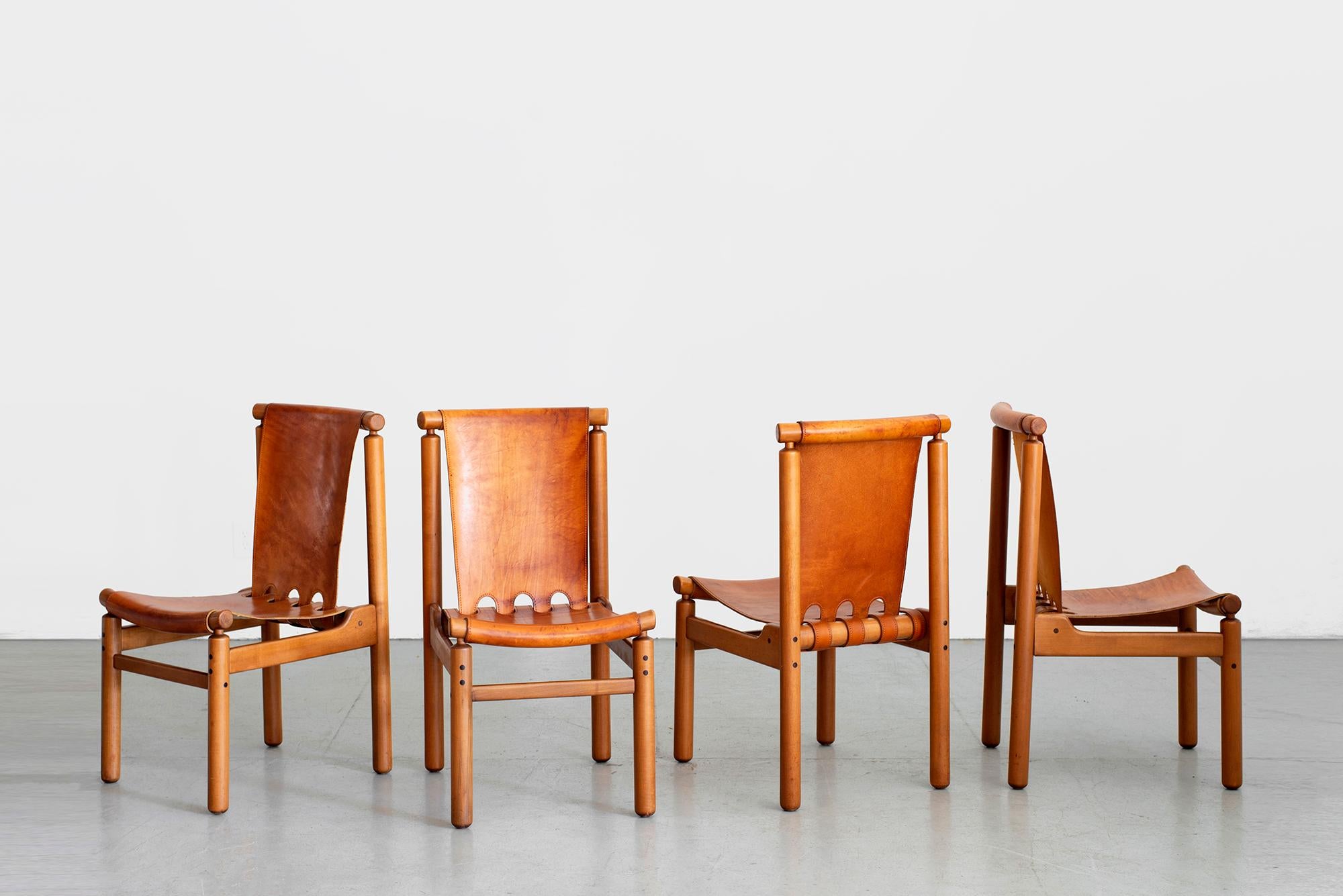 Incredible set of 4 leather Italian dining chairs by Ilmari Tapiovaara for La Permanente Mobili Cantù, circa 1950s.
Wonderful thick saddle leather with great patina'd leather on solid wood frames.
 