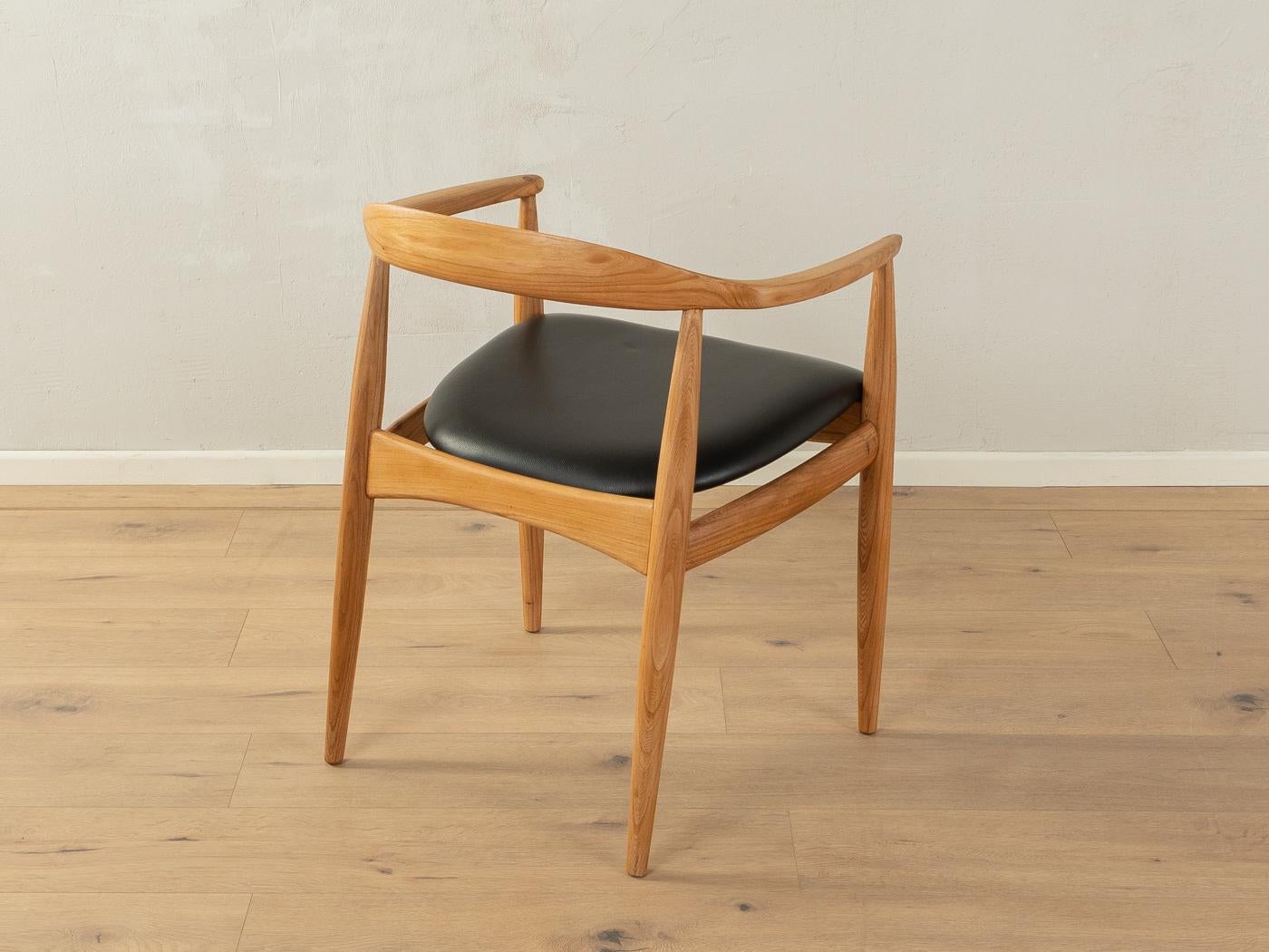 Classic Armchair by Illum Wikkelsø for Niels Eilersen, DK with an ash frame and the original leather cover in black.

Quality Features:
    accomplished design: perfect proportions and visible attention to detail
    high-quality workmanship using