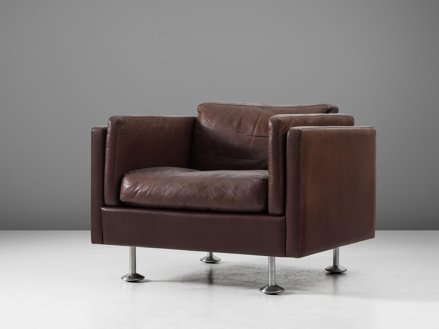 Illum Wikkelsoø, lounge chairs, in leather and stainless steel, Denmark, 1960s. 

Easy chair in dark brown leather, by Danish designer Illum Wikkelsø. This club chair has a cubic design. The tight and clean outside is complemented with a soft and