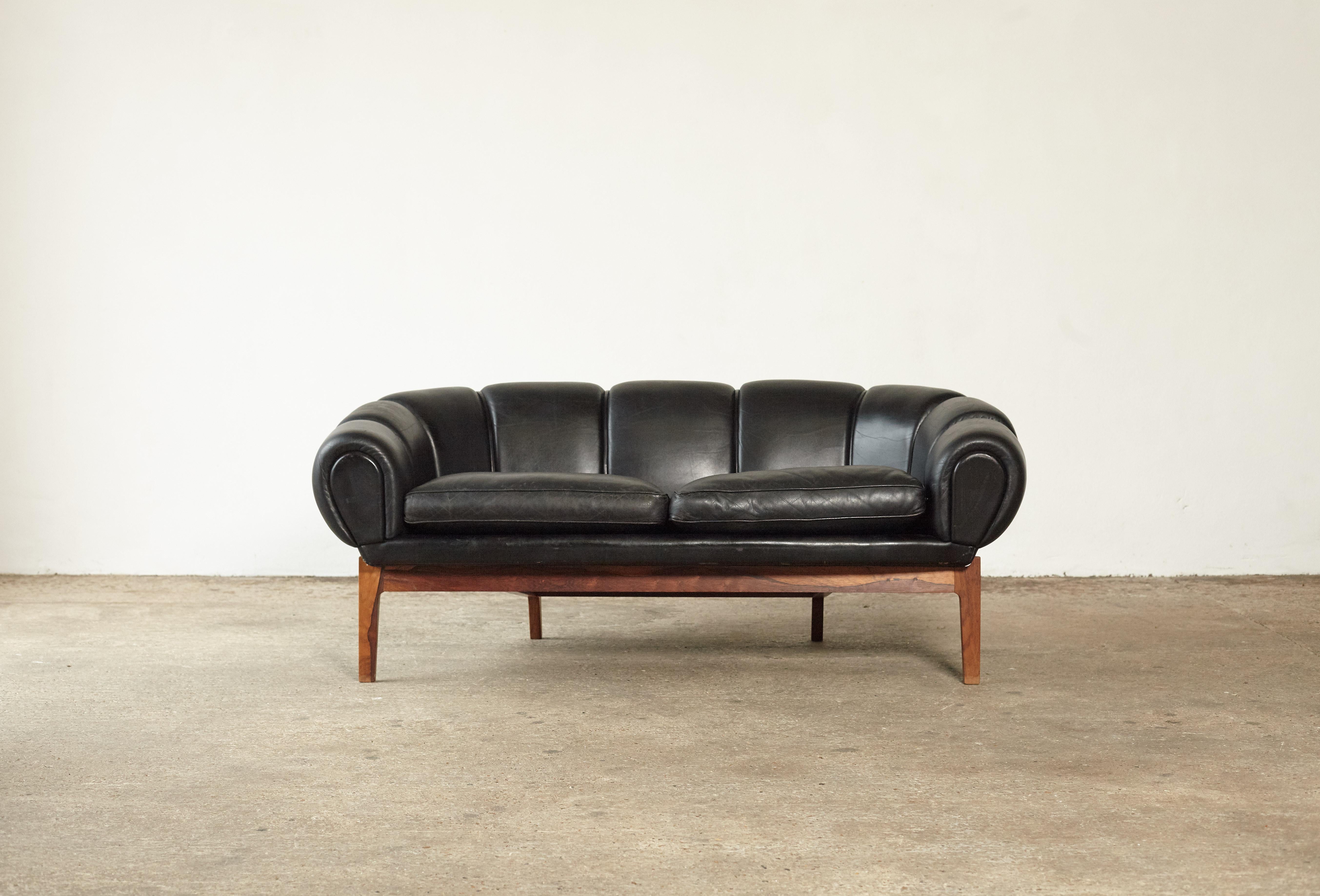 A very rare Illum Wikkelsø Croissant sofa produced by Holger Christiansen, Denmark, 1950s. Rosewood frame and original black leather. Good vintage condition with some signs of use and wear to leather.



  