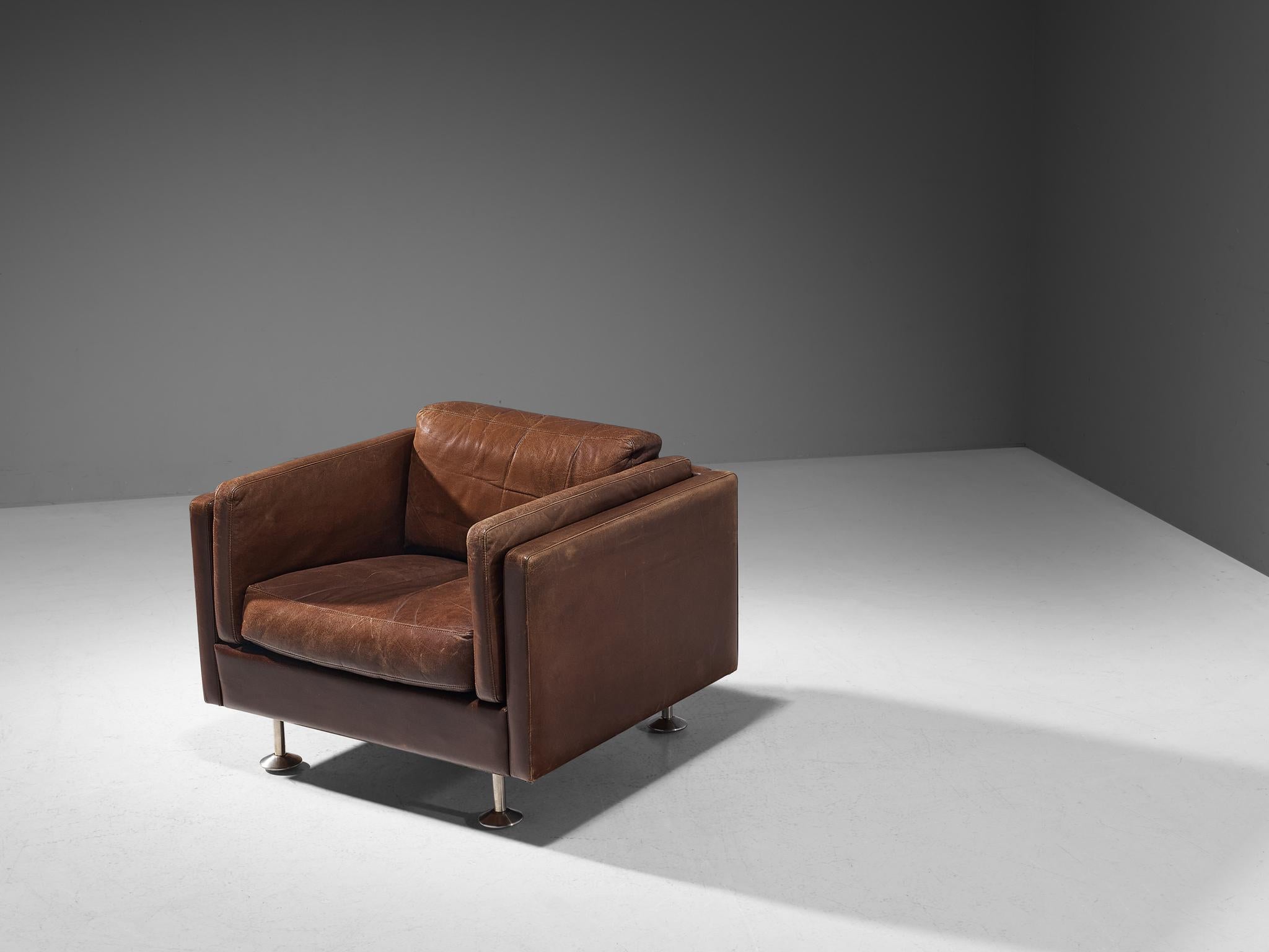 Illum Wikkelsø, lounge chair, leather, brushed steel, Denmark, 1960s. 

This eccentric club chair is well-executed embodying a solid construction. The seating is characterised by clear lines and right-angled shapes that contribute to the chair's