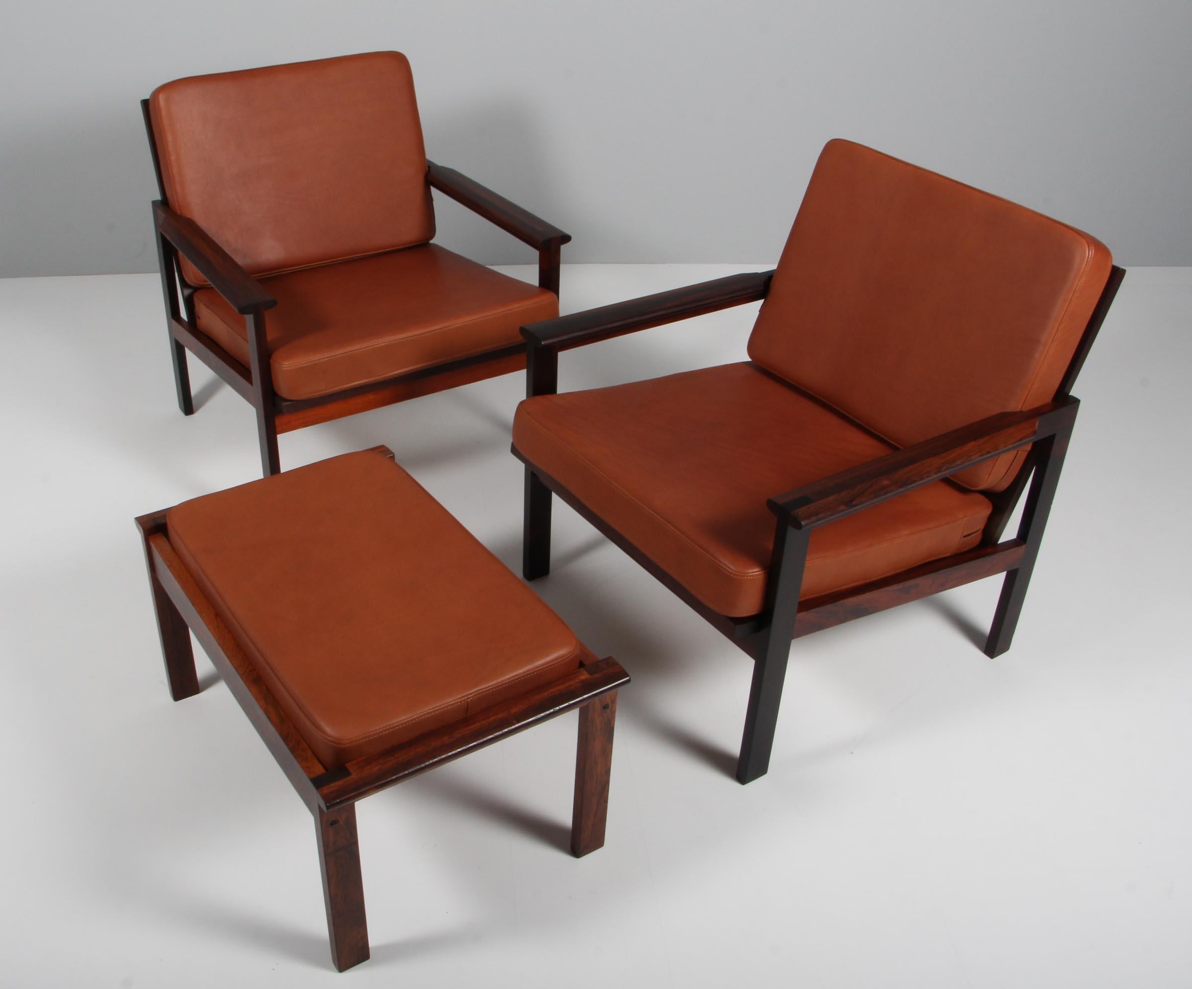 Illum Wikkelso for N. Eilersen Lounge chairs and an ottoman of solid rosewood.

New upholstered with tan aniline leather.

Model Capella, made by N. Eilersen.
 