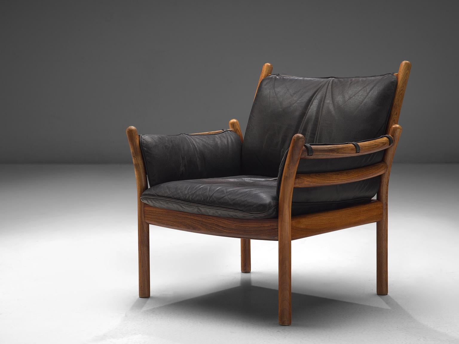 Illum Wikkelsø by CFC Silkeborg, 'Genius' chair, leather and rosewood, Denmark, 1950s.

This chair is made out of solid rosewood and features a black leather cushion on both seat and back. The chair is created as a sort of slatted rosewood basket.