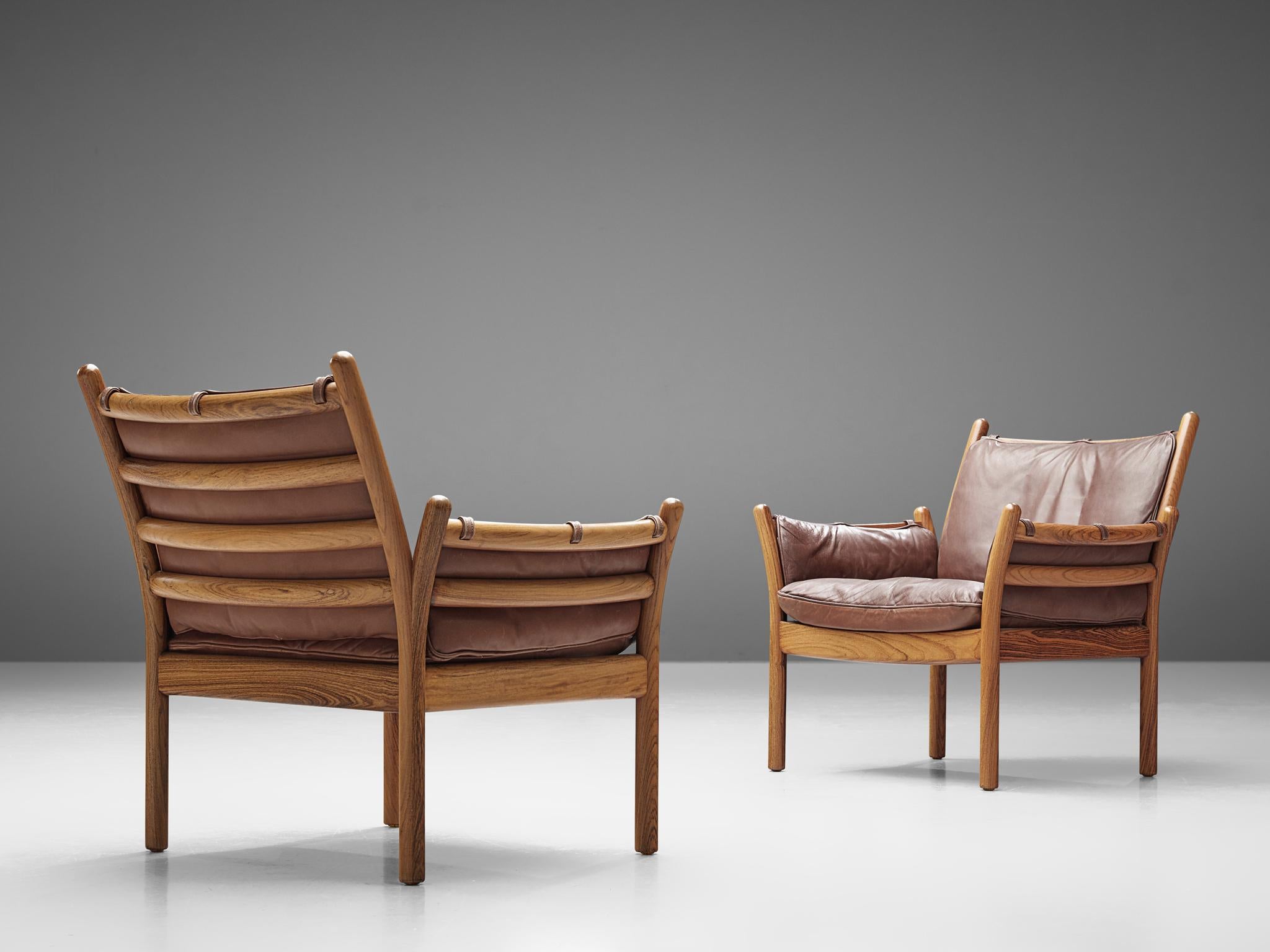 Illum Wikkelsø by CFC Silkeborg, 'Genius' chairs, leather and rosewood, Denmark, 1950s.

This chair is made out of solid rosewood and features a cognac leather cushion on both seat and back. The chair is created as a sort of slatted rosewood