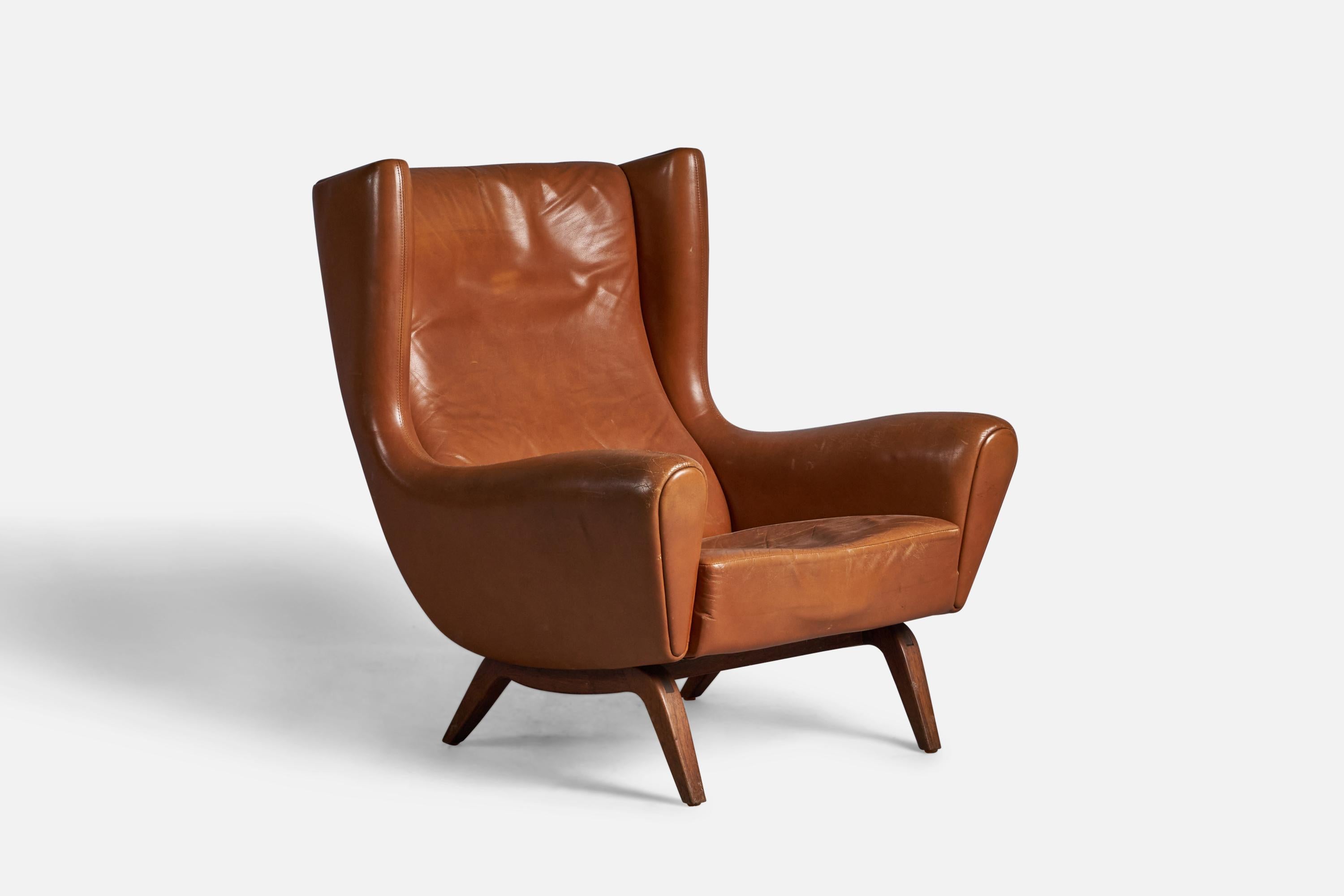 A leather and rosewood lounge chair designed by Illum Wikkelsø and produced by Søren Willadsen, Vejen, Denmark, 1960s.

14.5