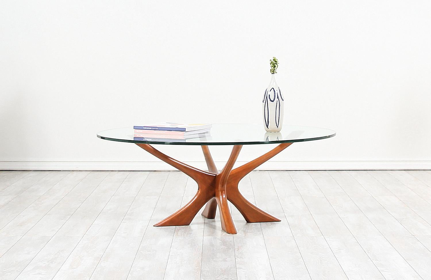 Stylish sculpted modern table designed by Illum Wikkelsø for CFC Silkeborg in Denmark circa 1950s. Also referred to as the JAX table this iconic design features a gracefully sculpted biomorphic teak base with a branch like structure that resembles