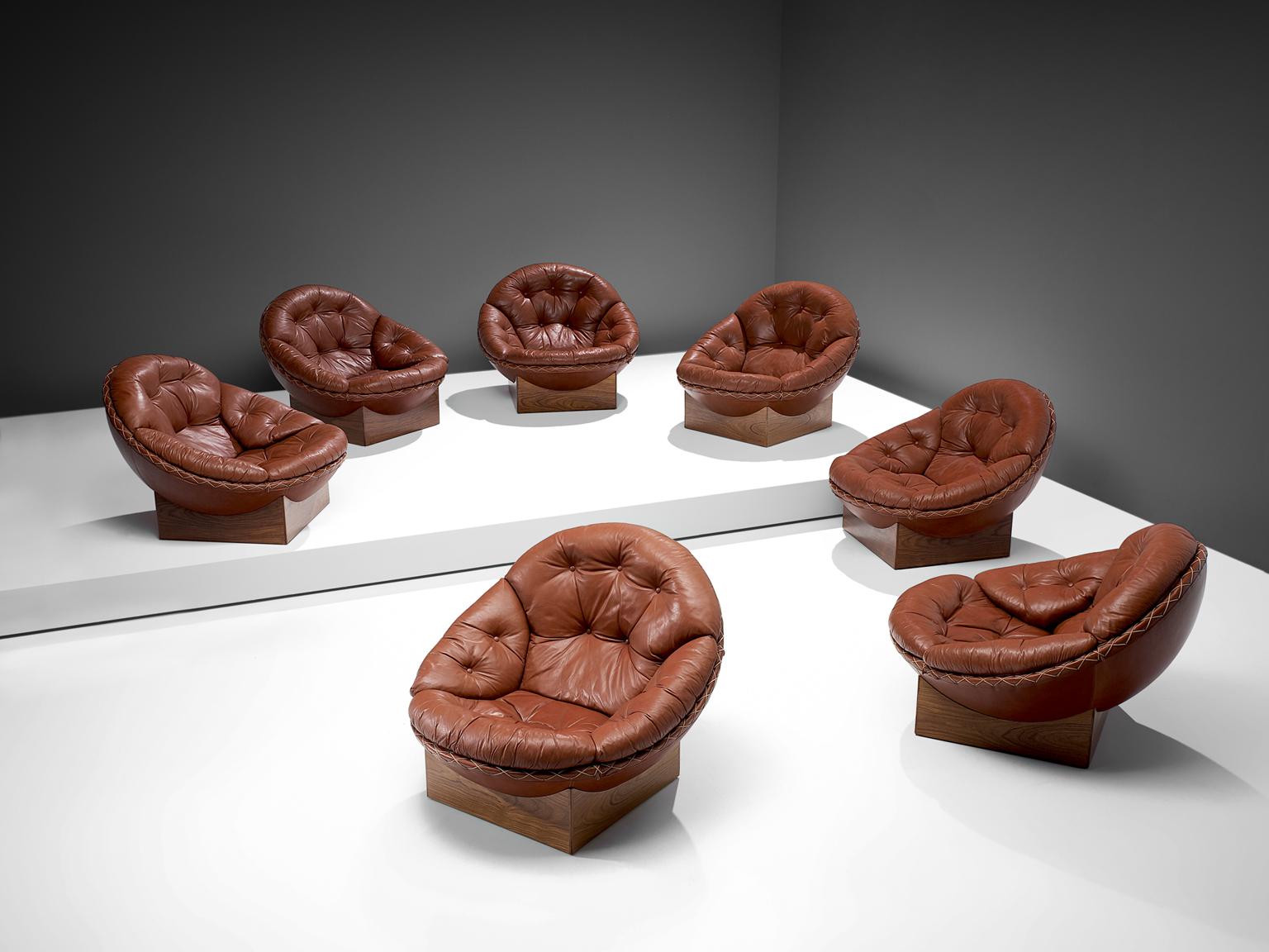 Illum Wikkelsø for Ryesberg Møbler, large set of lounge chairs, red leather, rosewood, Denmark, 1960s. 

This is a rare set of seven bowl chairs by Illum Wikkelsø for Ryesberg Møbler. The chairs are still covered in their original leather, which