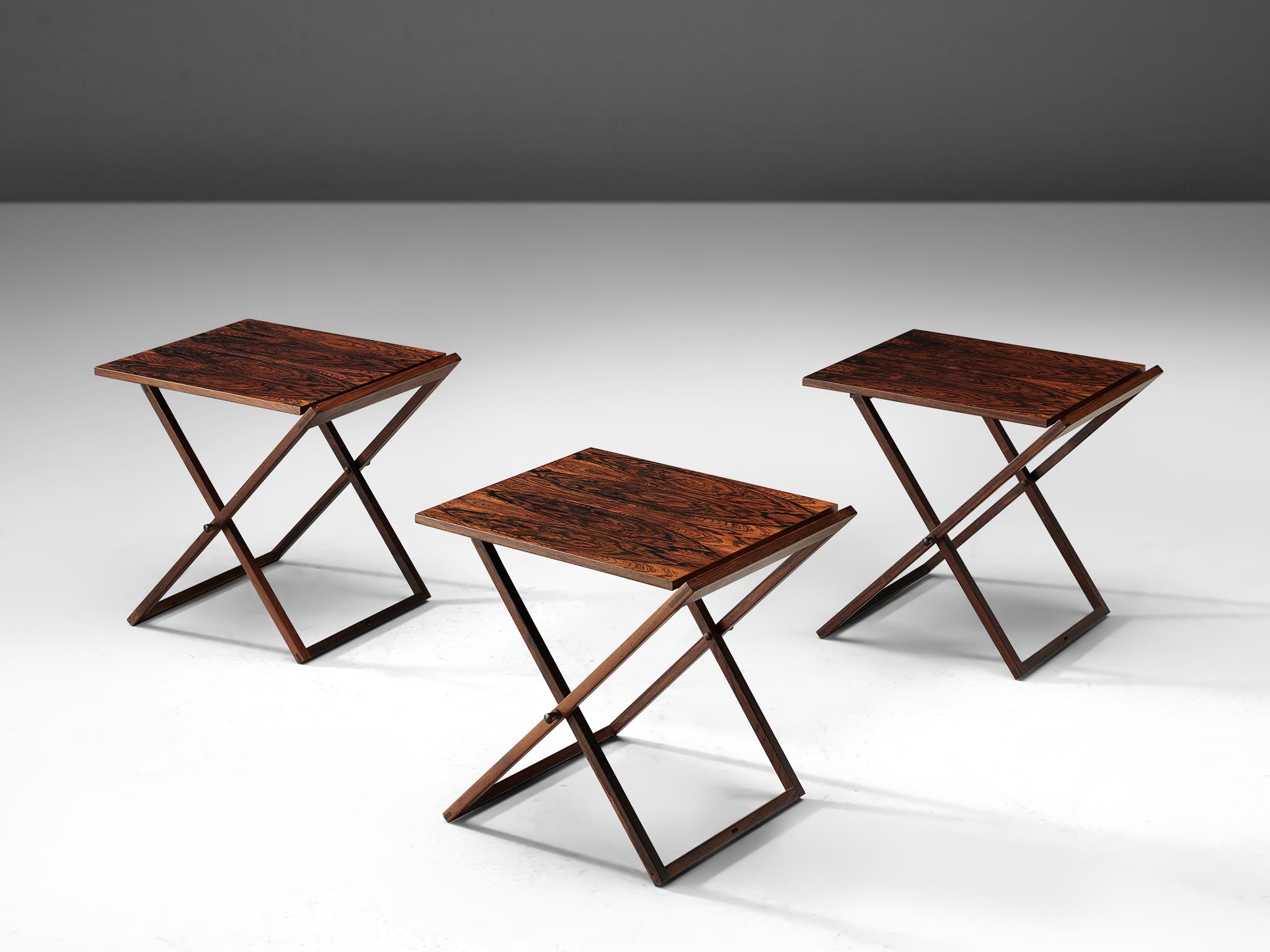 Illum Wikkelsø for Silkenborg, set of three side tables, rosewood and copper, Denmark, 1950s.

This set, that is designed by Illum Wikkelsø was made by cabinet maker Silkenborg. The tables are executed in rosewood with detailing such as the hinges