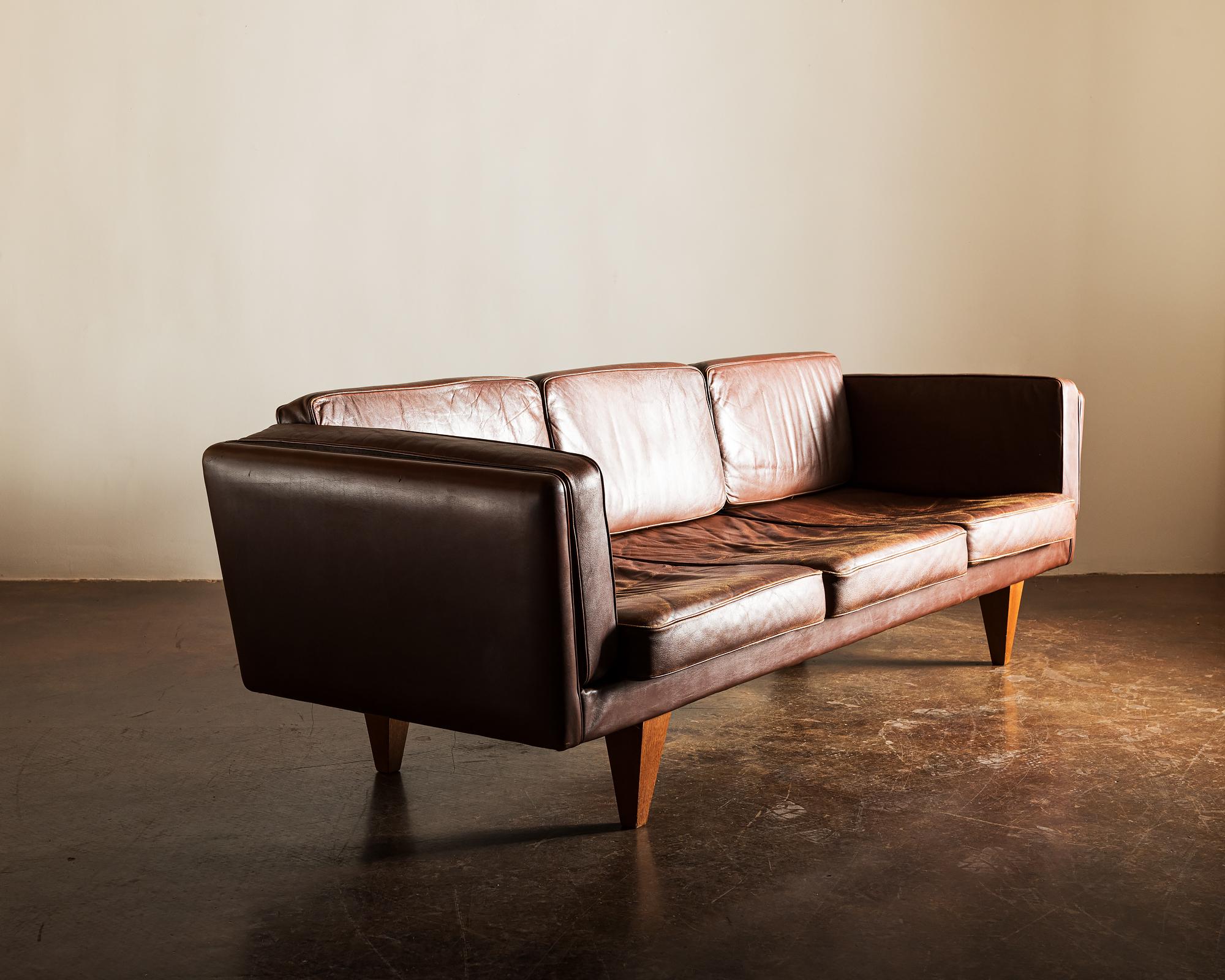 A nice example of the rare sculptural V11 by Illum Wikkelso. In brown leather with nice patina. Designed for Holger Christiansen, Denmark, 1960s.
