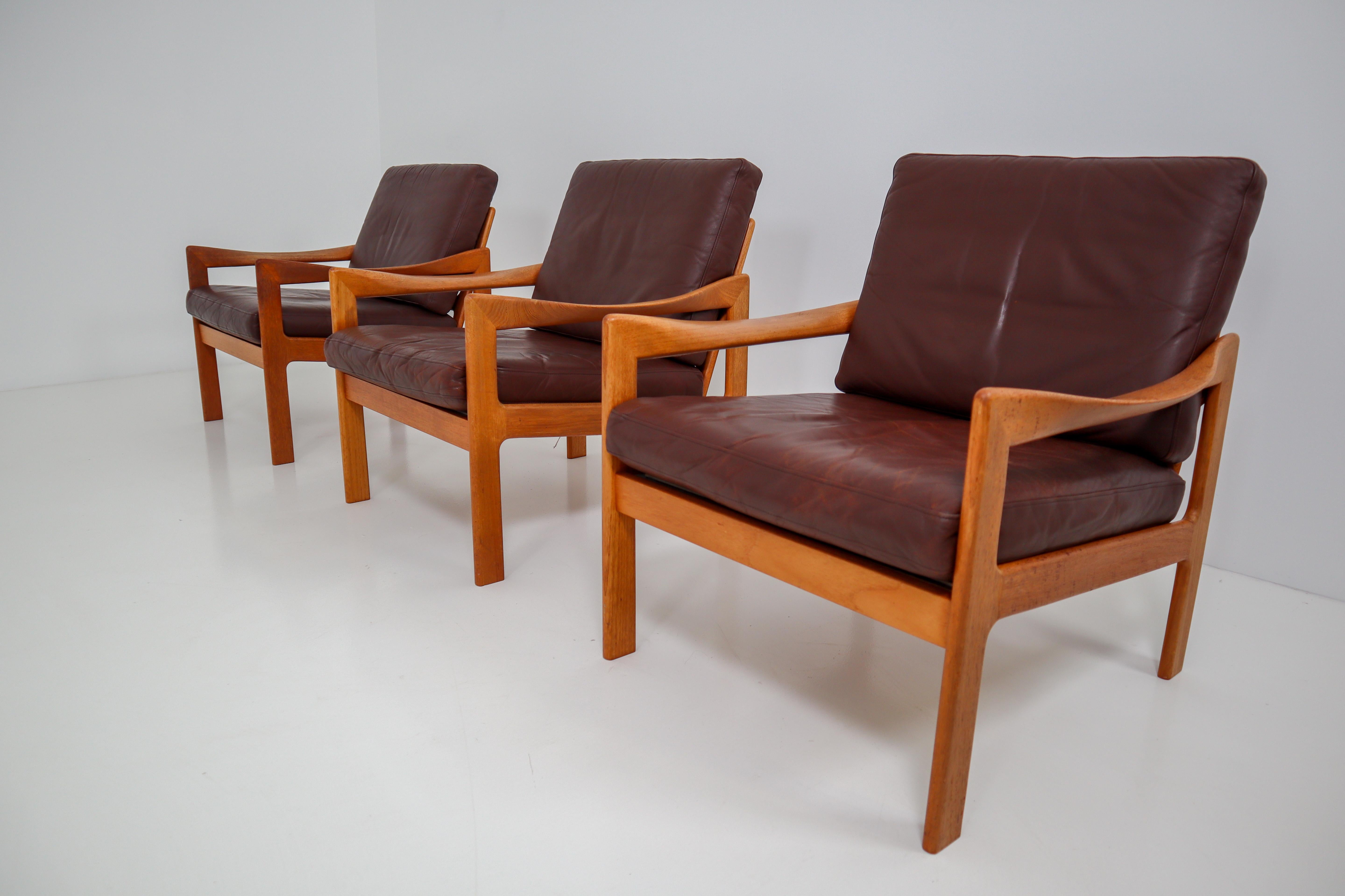A teak armchair designed by Illum Wikkelsø and produced by Eilersen, Denmark, circa 1960. This beautiful midcentury Danish armchair has wonderfully twisted armrests and original leather upholstery with minor signs of usage and patina. A very