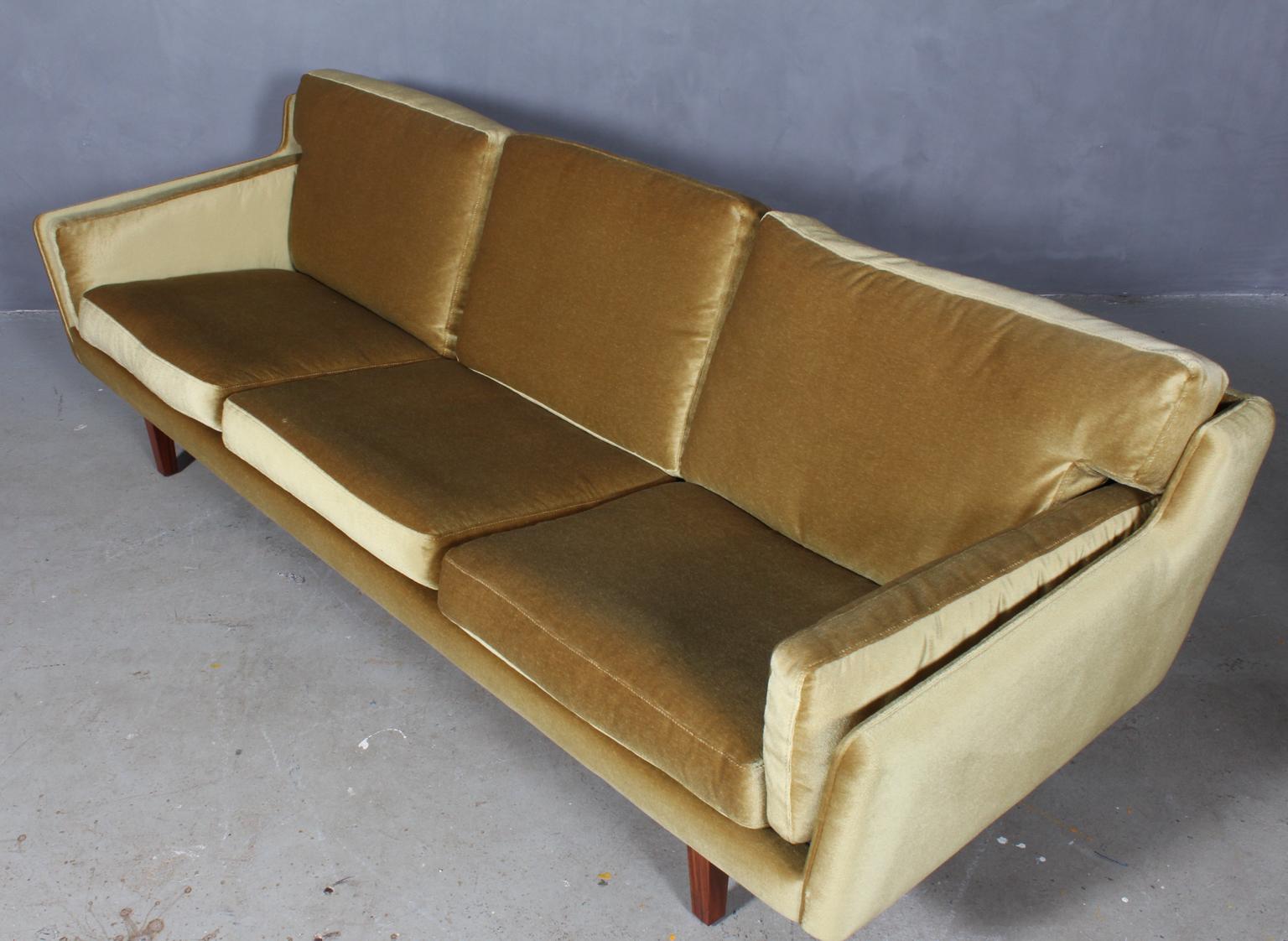 Illum Wikkelsø three-seat sofa original upholstered with velvet.

Legs of rosewood.

Made by Holger Christiansen.