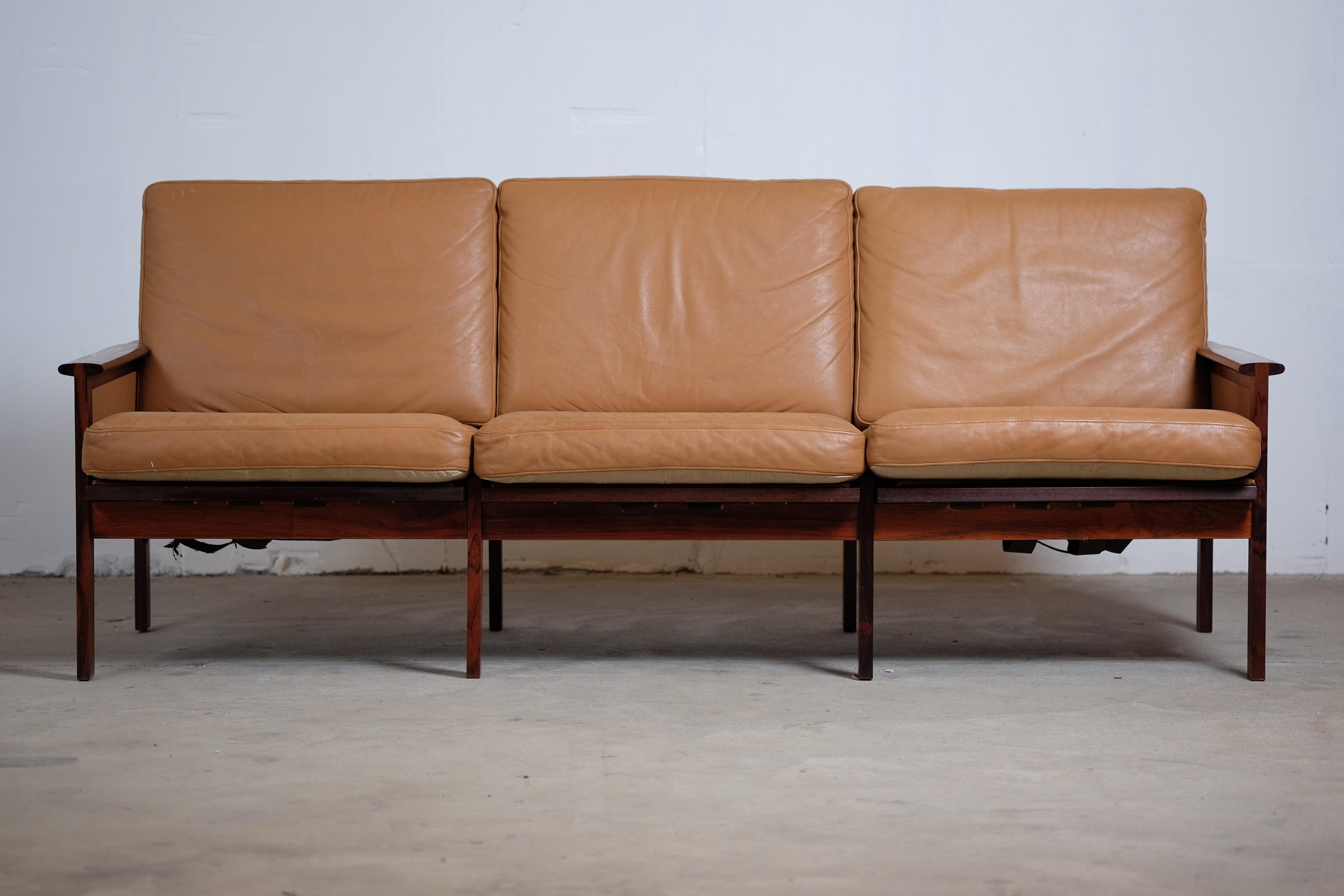 This beautiful rosewood sofa was designed by Illum Wikkelsø and manufactured by N. Eilersen. This sofa also comes in a two-seat and there has also been made a easy chair in that series. The leather cushions are in good vintage condition with a great