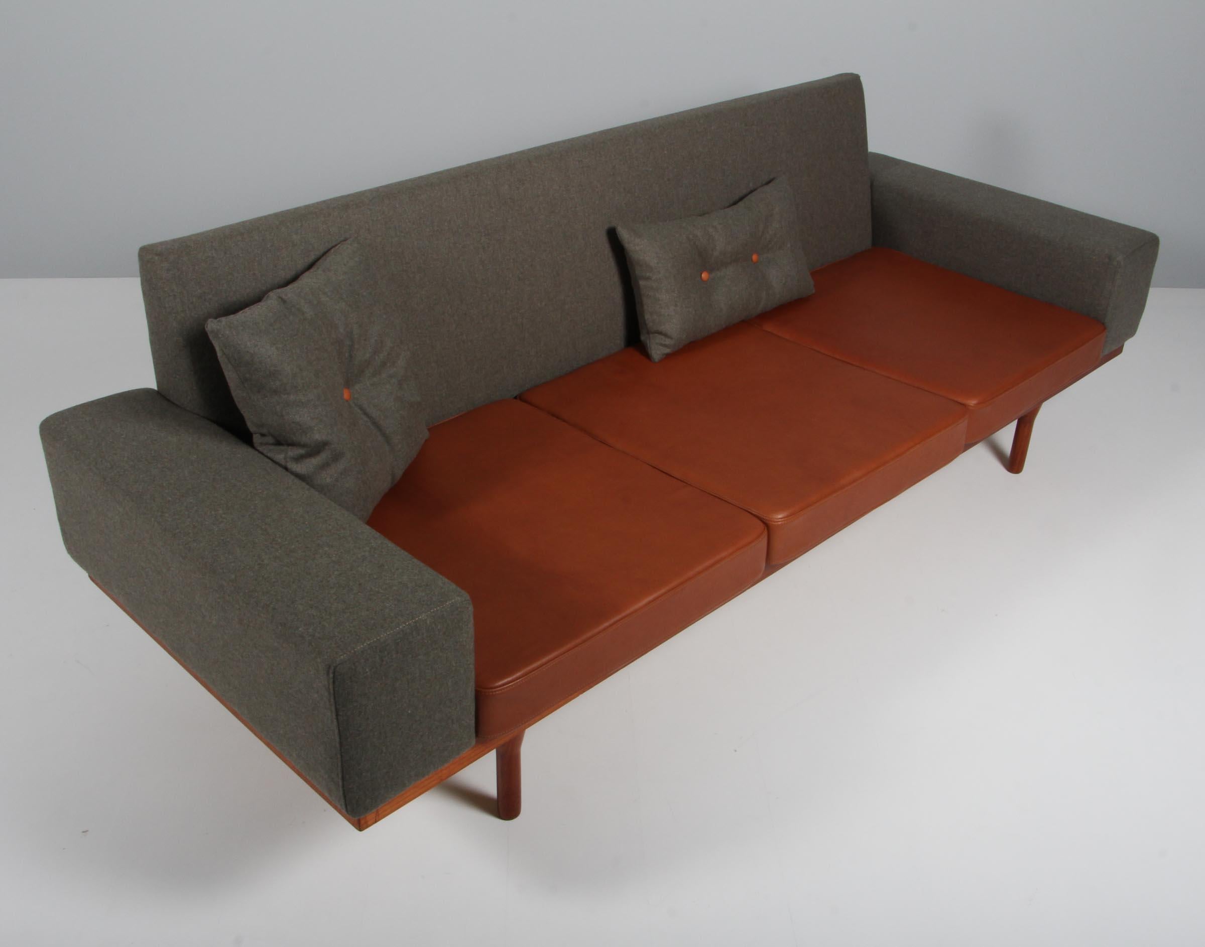 Illum Wikkelsø three-seat sofa new upholstered in magrethe wool and cognac aniline leather.

Frame in teak.

Model 50-3 Australia.
