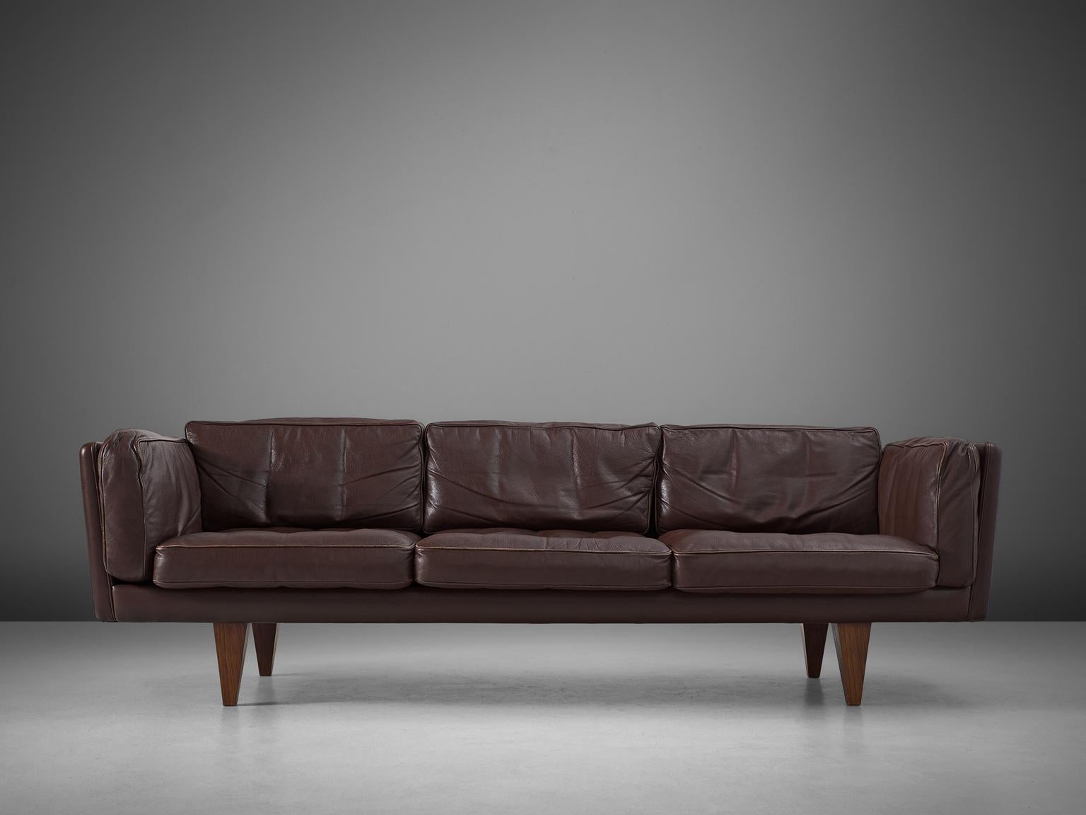 Illum Wikkelsø, sofa model V11, dark brown leather and wood, Denmark, 1960s.

Stunningly three-seat sofa, designed by Danish designer Illum Wikkelsø. Highly comfortable and beautiful designed sofa with brown leather upholstery. The nonchalant and