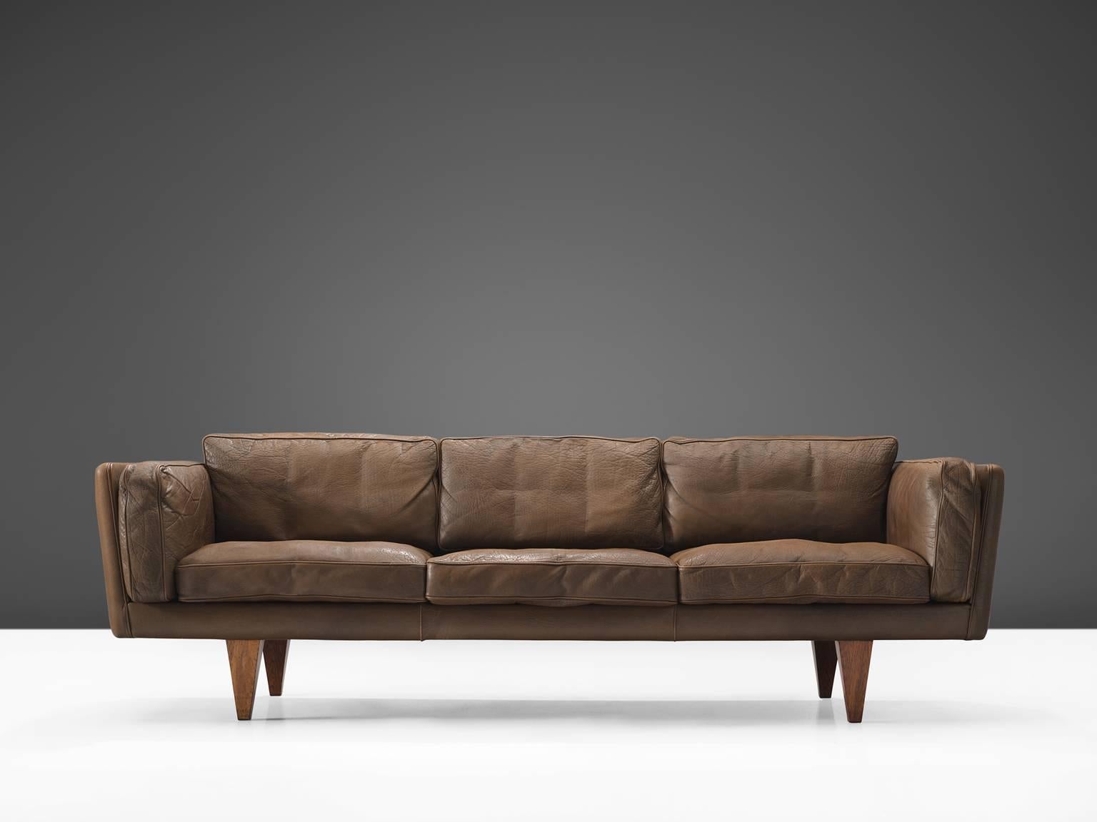 Illum Wikkelsø, sofa model V11, brown leather and wood, Denmark, 1960s.

This three-seat sofa is designed by Danish designer Illum Wikkelsø. Highly comfortable and beautiful designed sofa with dark brown leather upholstery. The dark brown high