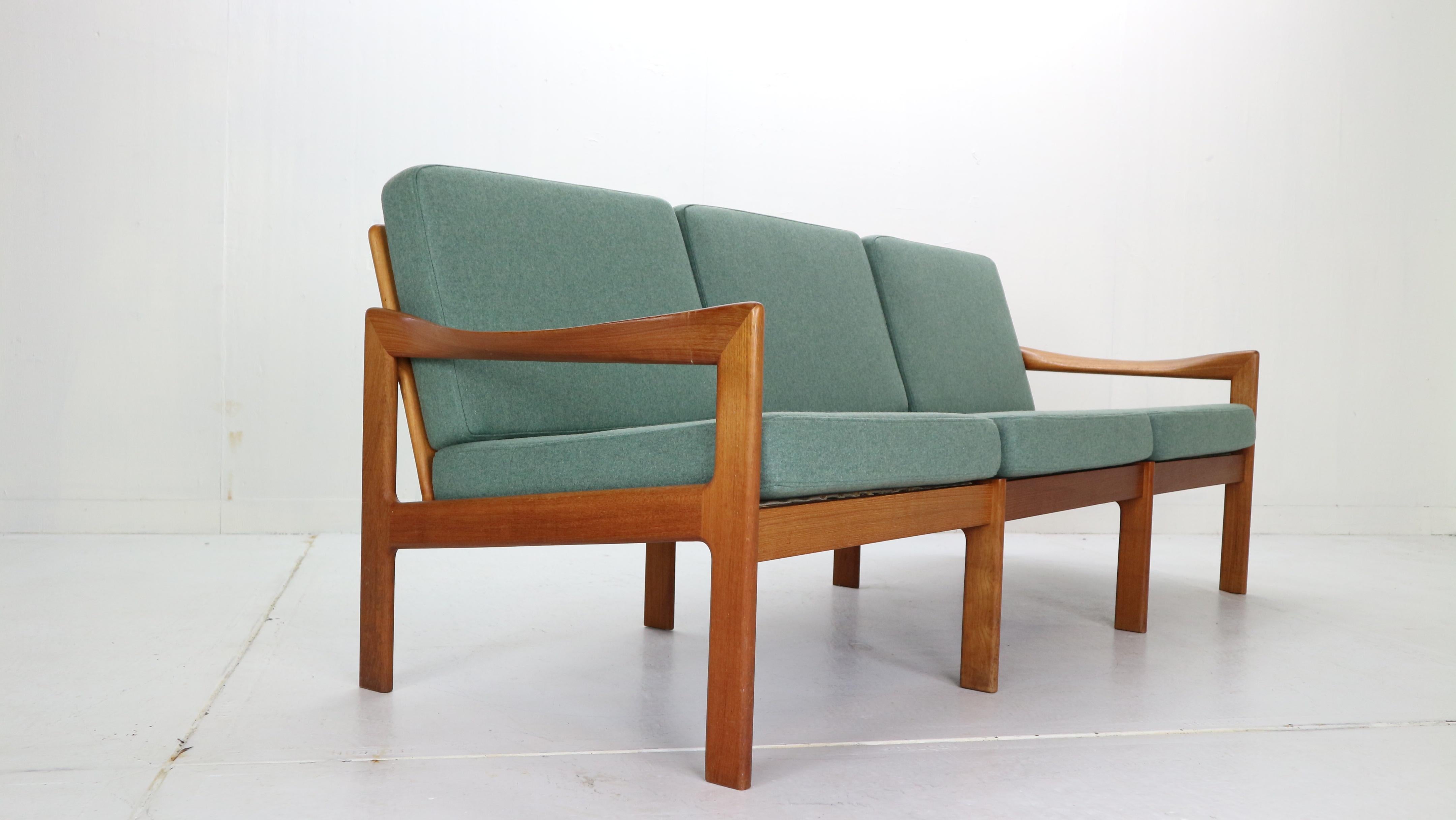 Scandinavian Modern period three-seat sofa designed by Illum Wikkelsø for Niels Eilersen, 1960, Denmark.
Curved teak wooden frame with beautiful details and backrest.
Seating has been newly upholstered with green wool furniture fabric.


       