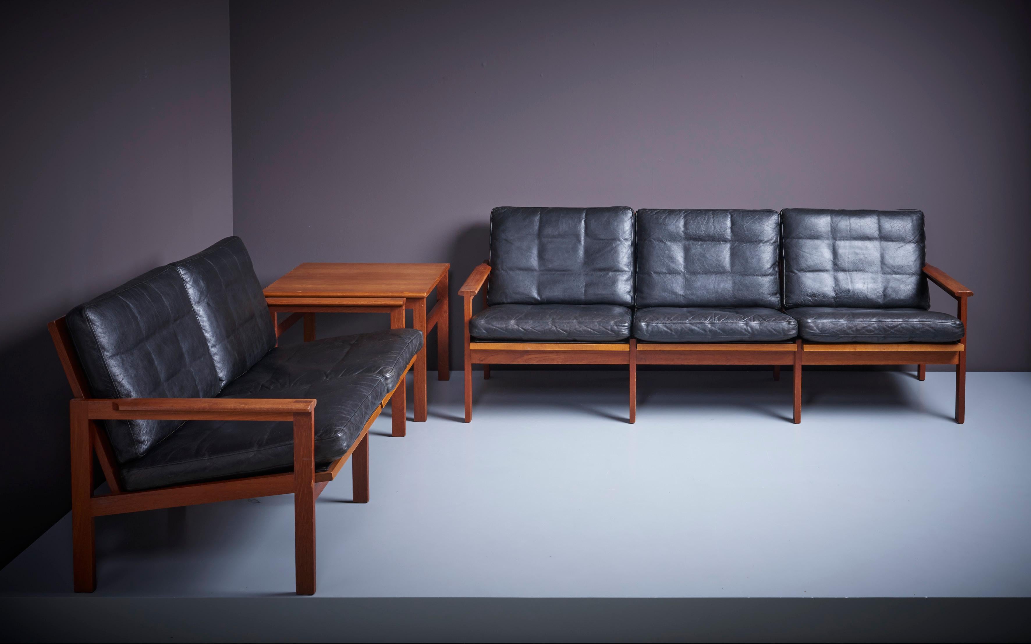 Original condition 'Capella' Set consisting of one 2 -seater sofa, one 3-seater sofa and a side table by Danish furniture designer Kristian Illum Wikkelsø (1919-1999) for Niels Eilersen. Outstanding quality with solid teak frames and beautiful black