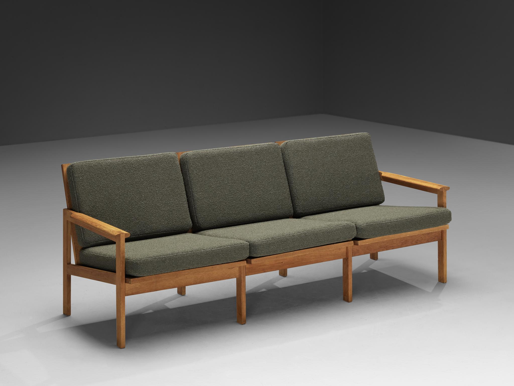Illum Wikkelso for Niels Eilersen, 'Capella' three seat sofa, oak, fabric, Denmark, 1950s

Timeless and elegant Illum Wikkelsø 'Capella' three-seat sofa. Crafted in the 1950s, this exquisite piece exemplifies the sophisticated simplicity and