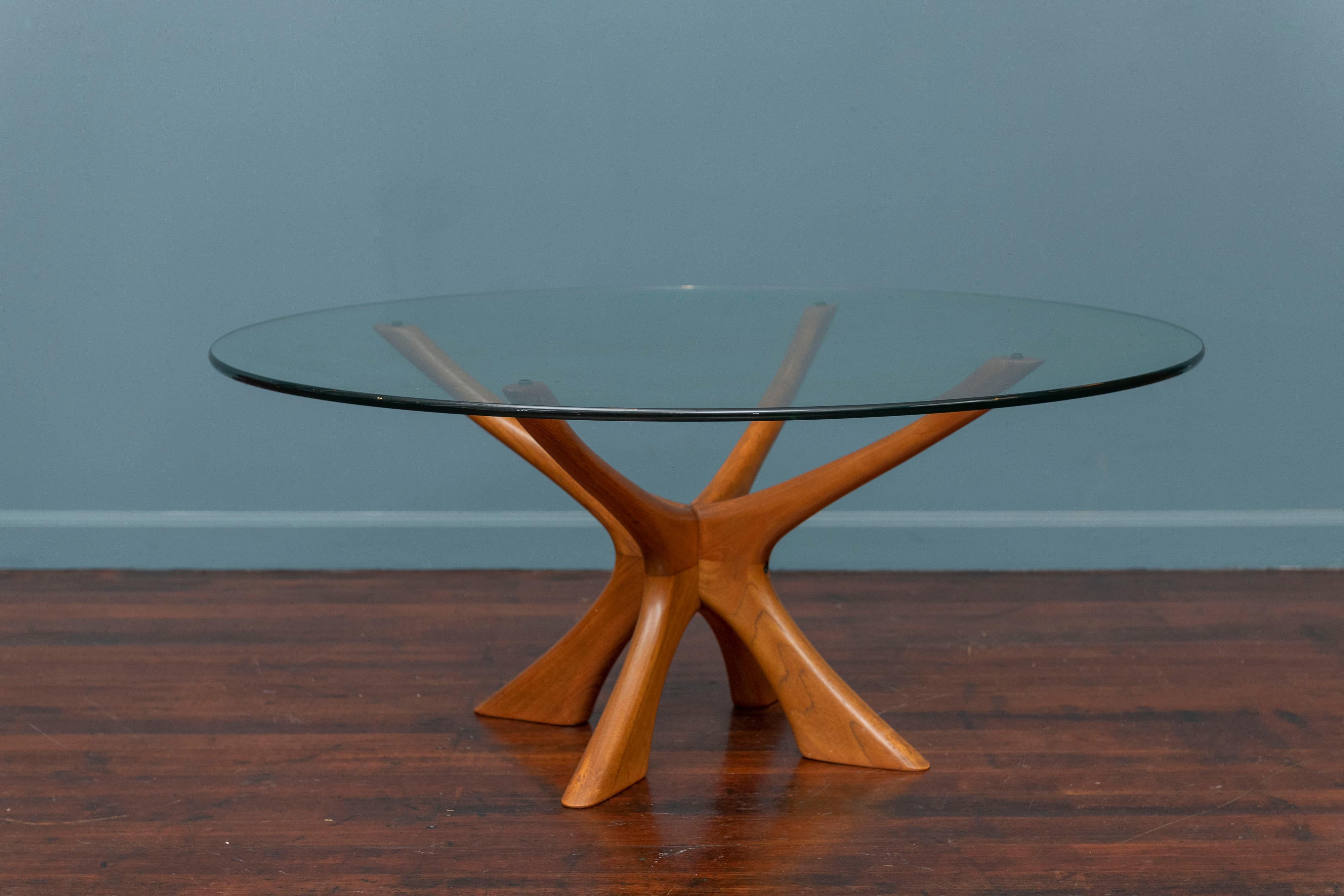 Scandinavian Modern Illum Wikkelso design teak and glass coffee table. Sculpted legs and arms in solid teak with a 42