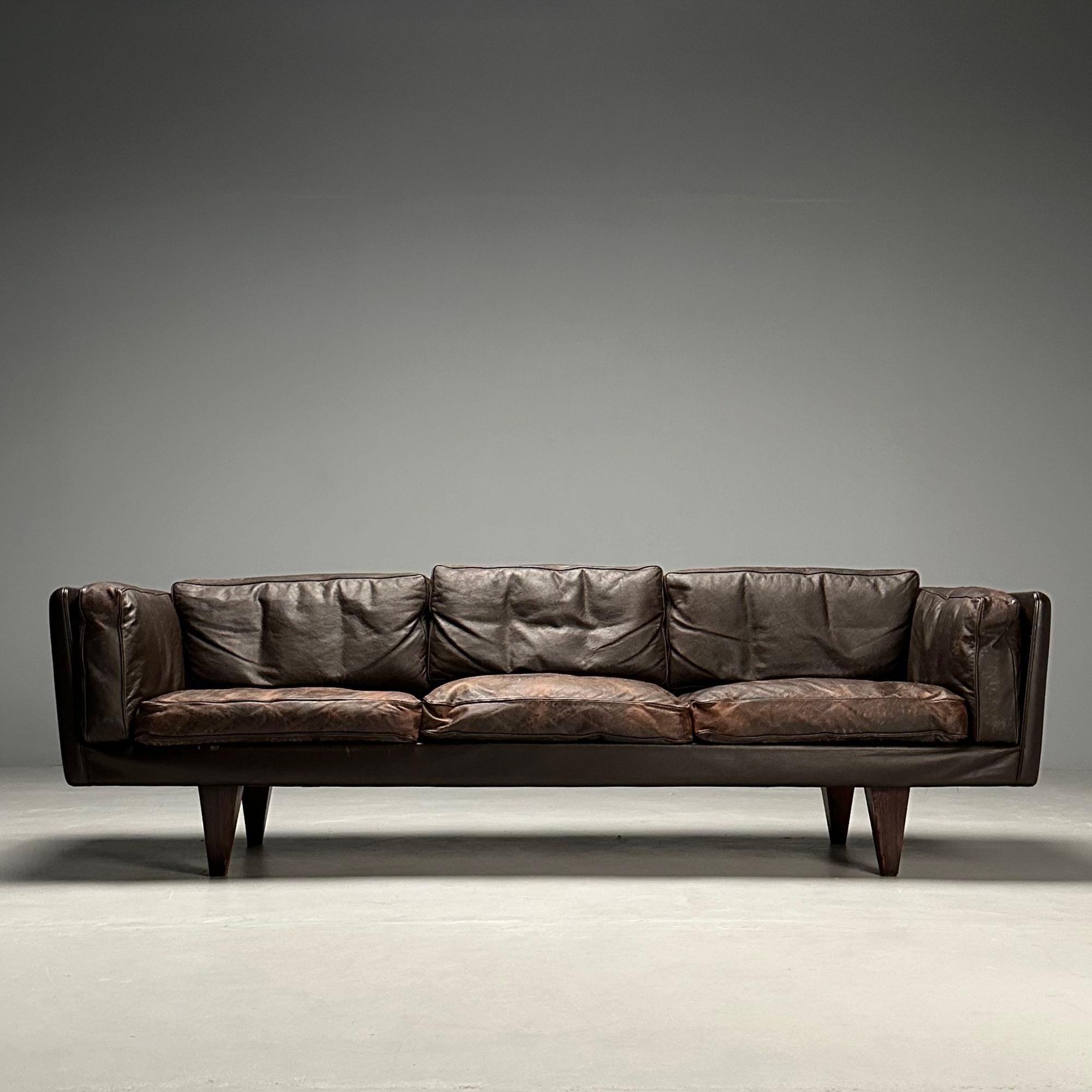 Illum Wikkelsö, Danish Mid-Century Modern, Rare Sofa, Distressed Brown Leather, Rosewood Legs, 1960s

An example of a three seater sofa designed by Illum Wikkelsö for Holger Christiansen in Denmark, 1960s. This model VII sofa maintains it's original
