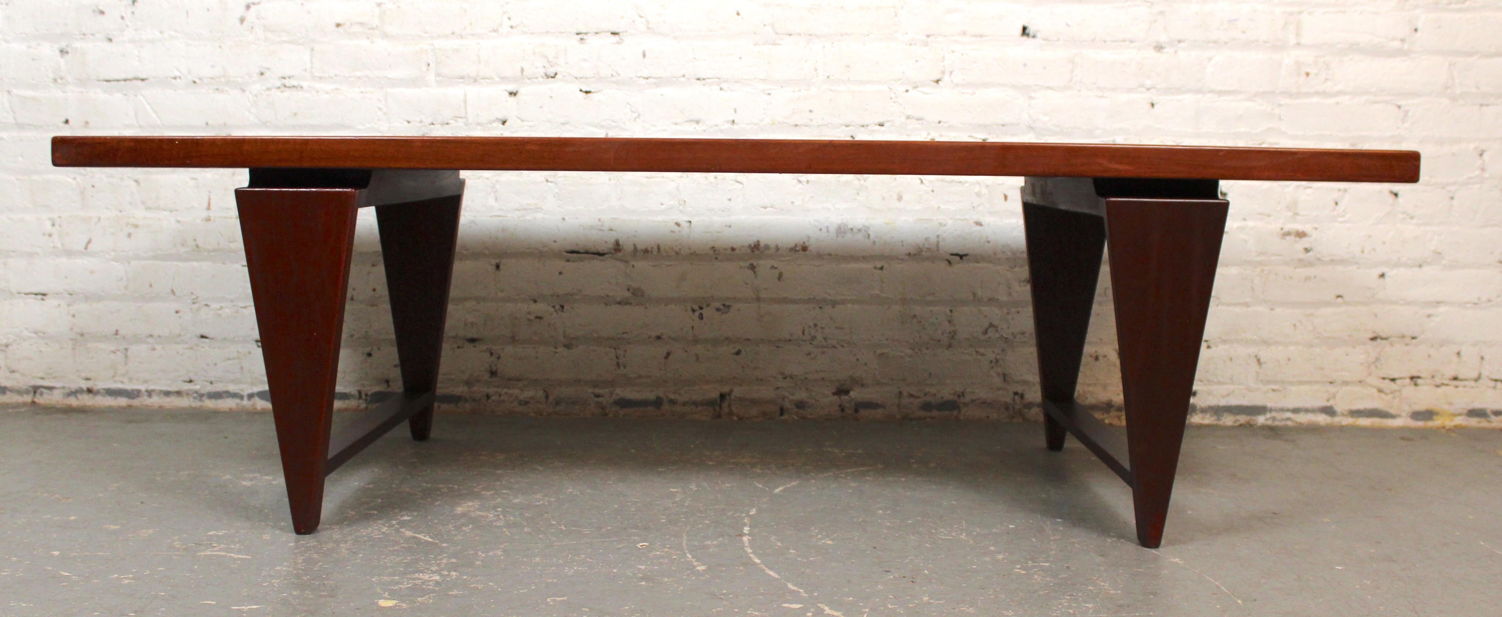 Illum Wikkelso pour A. Mikael Laursen table en bois de teck massif. Magnifique design avec des pieds en forme de coin ou de triangle et des supports transversaux. La construction donne un effet flottant à la partie supérieure. Il s'agit d'une table