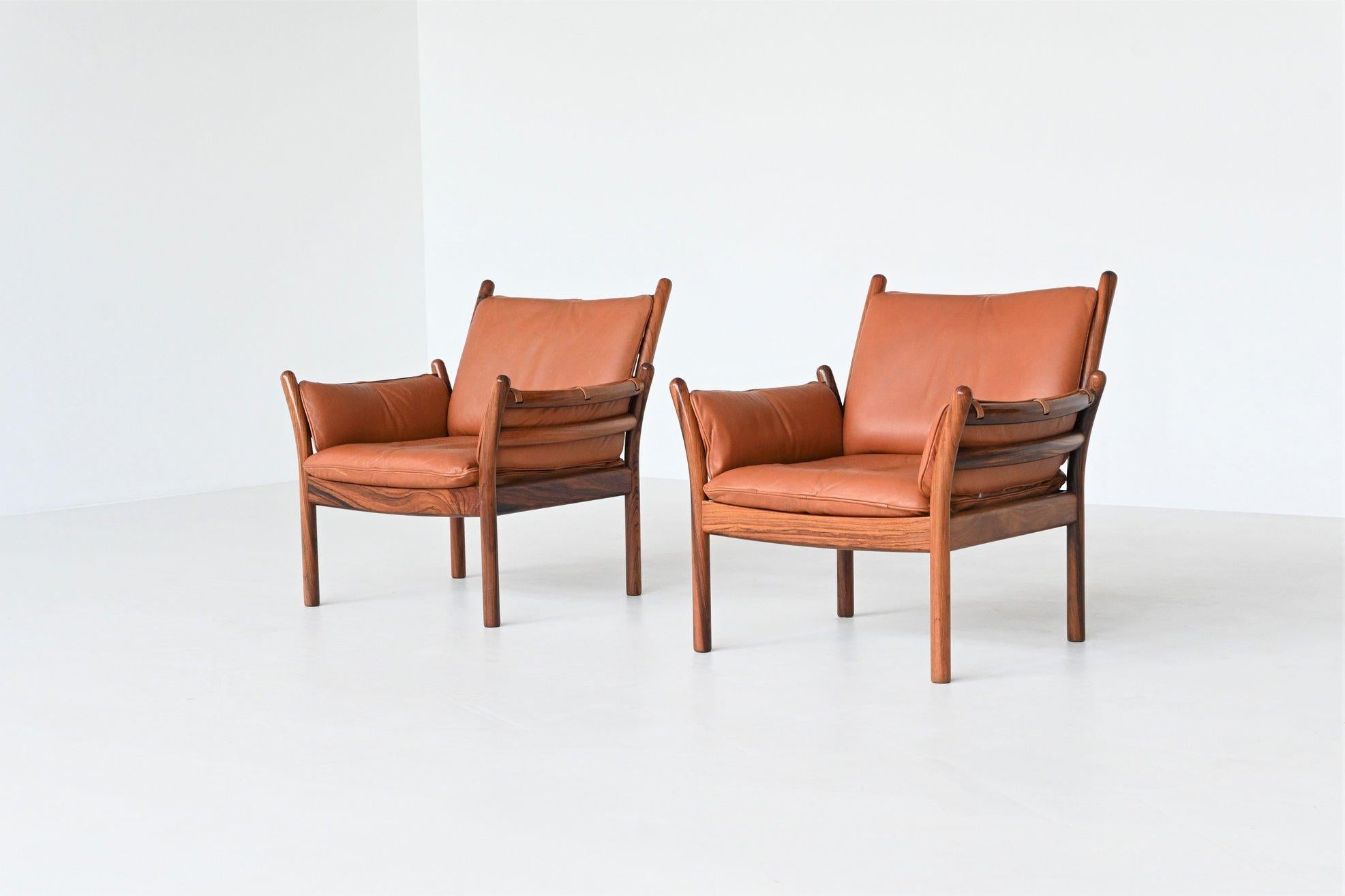Superb shaped pair of “Genius” lounge chairs designed by Illum Wikkelsø and manufactured by CFC Silkeborg, Denmark 1960. These elegant chairs have a beautiful open character. The cylindrical solid rosewood legs run smoothly over into the back and
